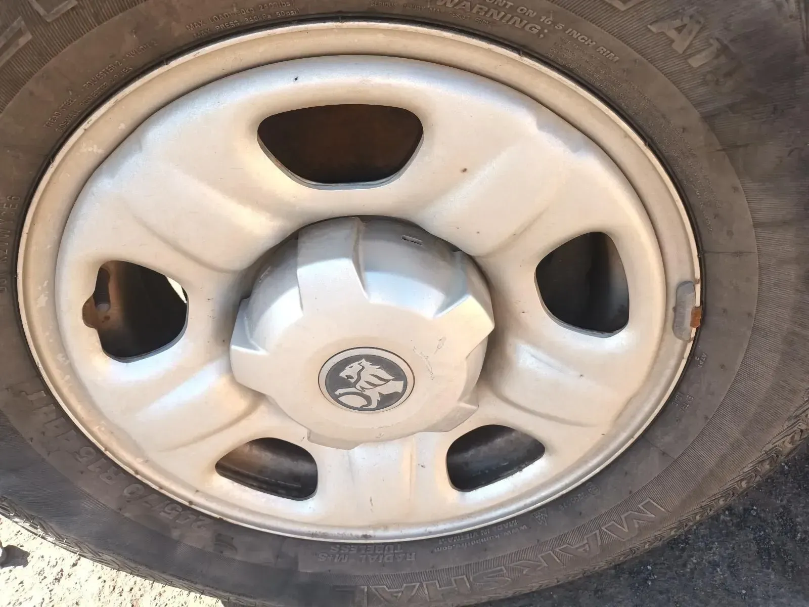Close-up of a Holden Car Wheel With a Silver Hubcap and Tyre — South West 4WD Wreckers In Brisbane, QLD
