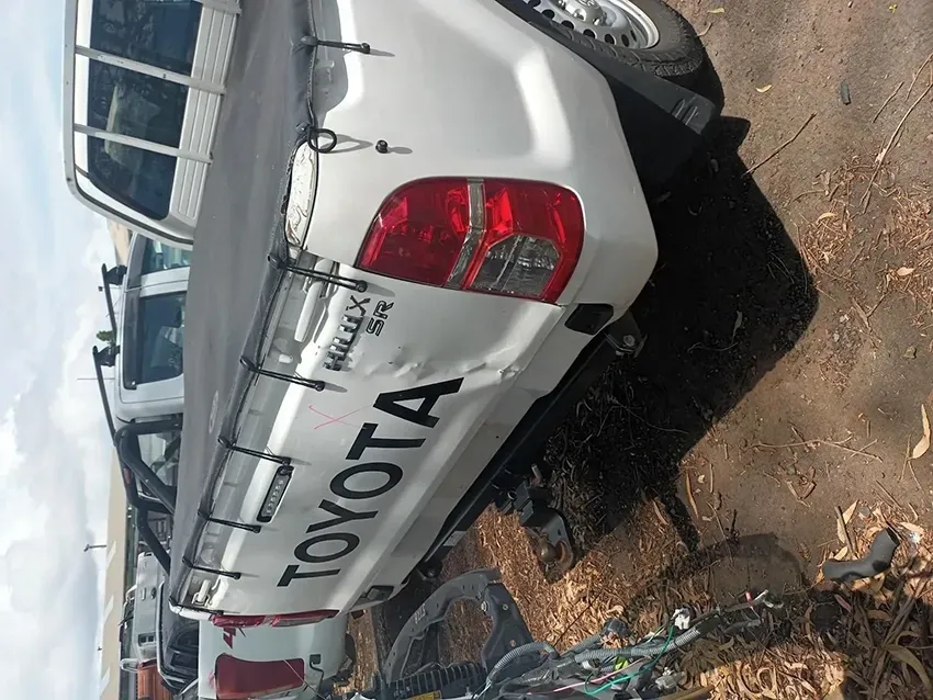 A White Toyota Truck is Parked on the Side of the Road — South West 4WD Wreckers In Brisbane, QLD
