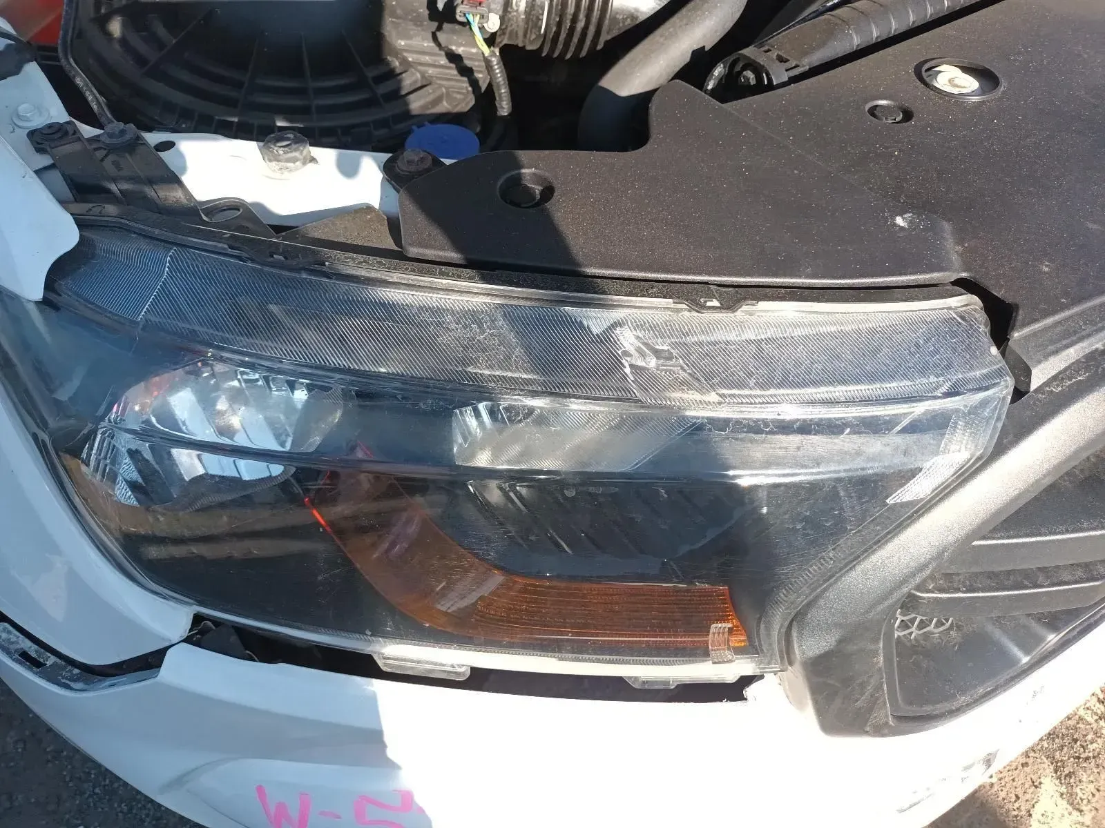 Damaged Car Headlight With Cracked Lens and Amber Indicator — South West 4WD Wreckers In Brisbane, QLD