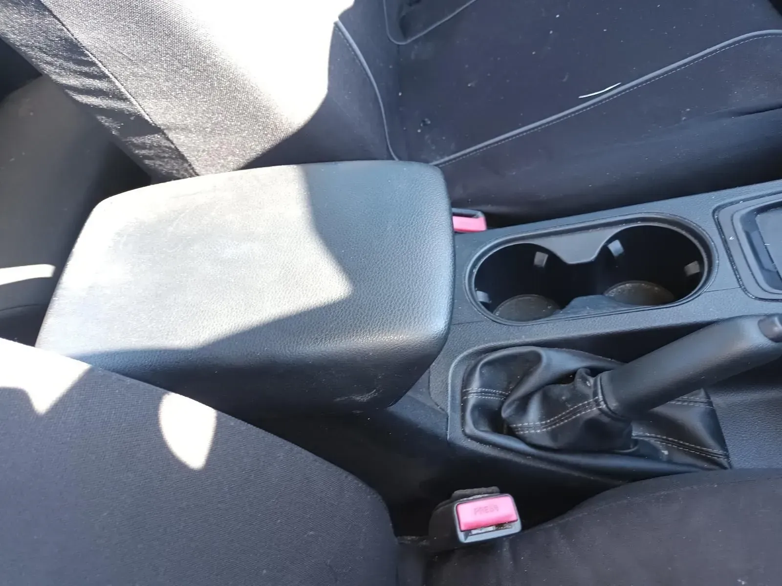 Black Car Console With Armrest, Cupholders, Gearshift, and Seatbelts — South West 4WD Wreckers In Brisbane, QLD