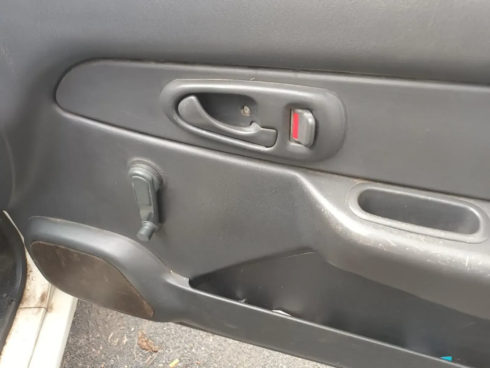 Car Door Interior With a Gray Panel, Handle, Window Crank, and Red Lock Indicator — South West 4WD Wreckers In Brisbane, QLD