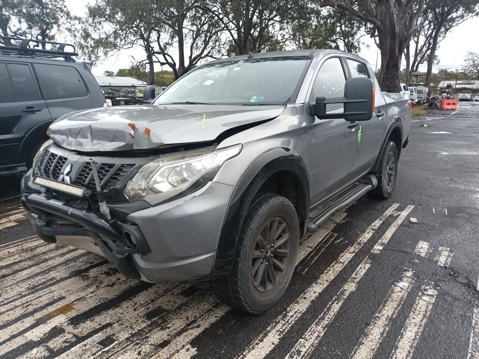 A White Truck is Parked in a Parking Lot in Front of a Building — South West 4WD Wreckers In Brisbane, QLD