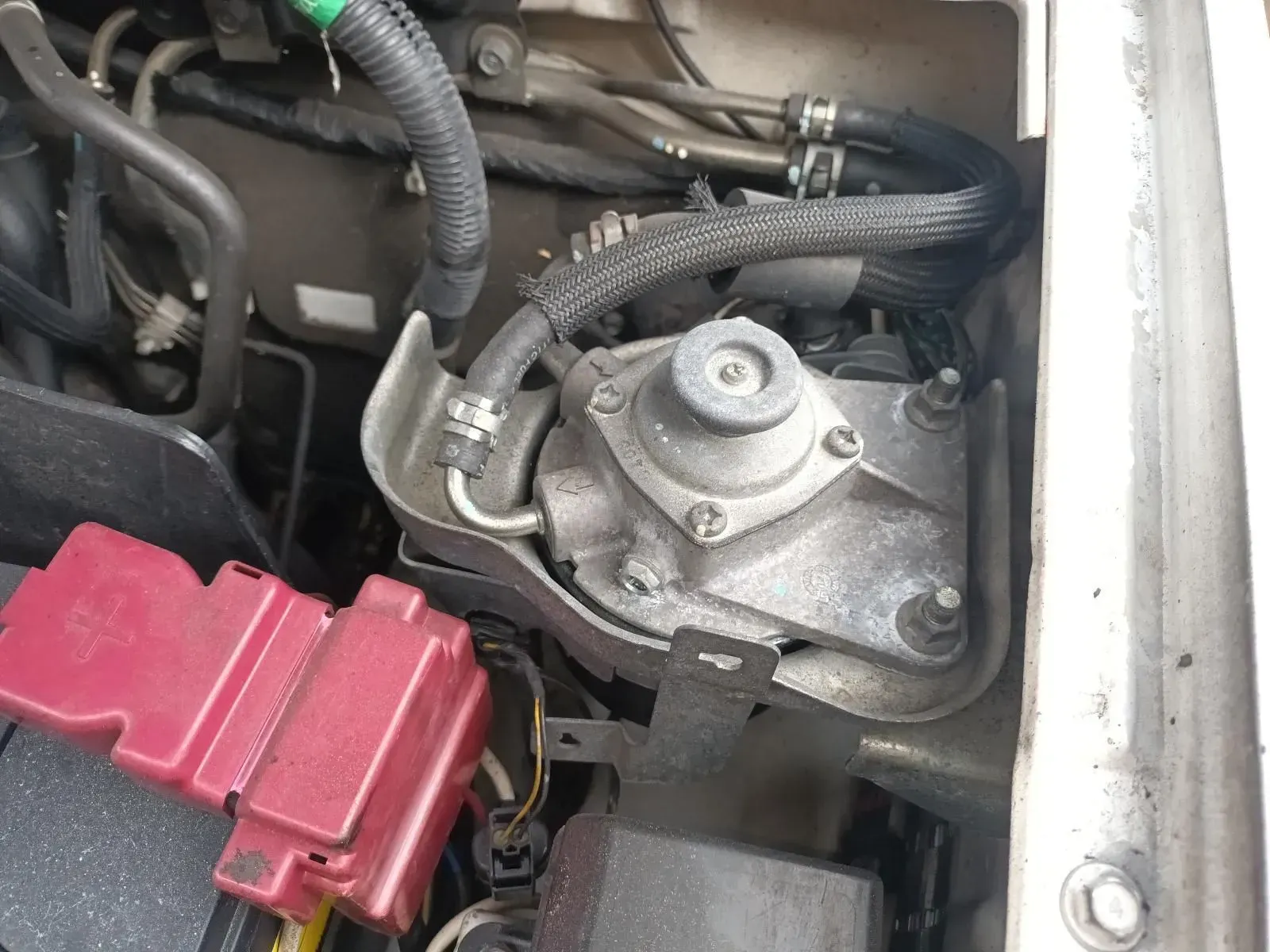 Engine Compartment With a Gray, Circular Component and Red Fuse Boxes — South West 4WD Wreckers In Brisbane, QLD