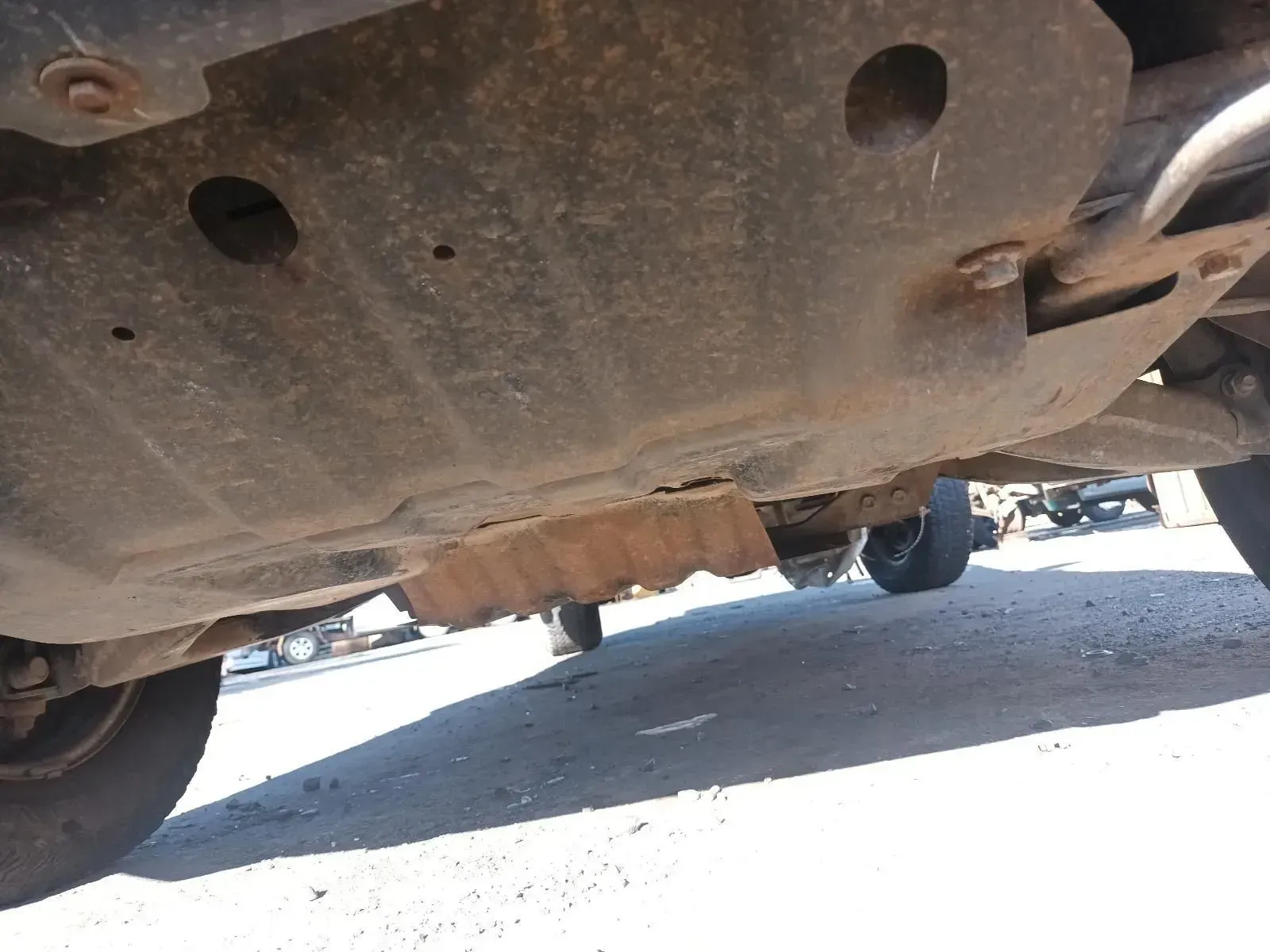 Underside of a Rusty Vehicle, Showing Protective Plate and Road Surface — South West 4WD Wreckers In Brisbane, QLD