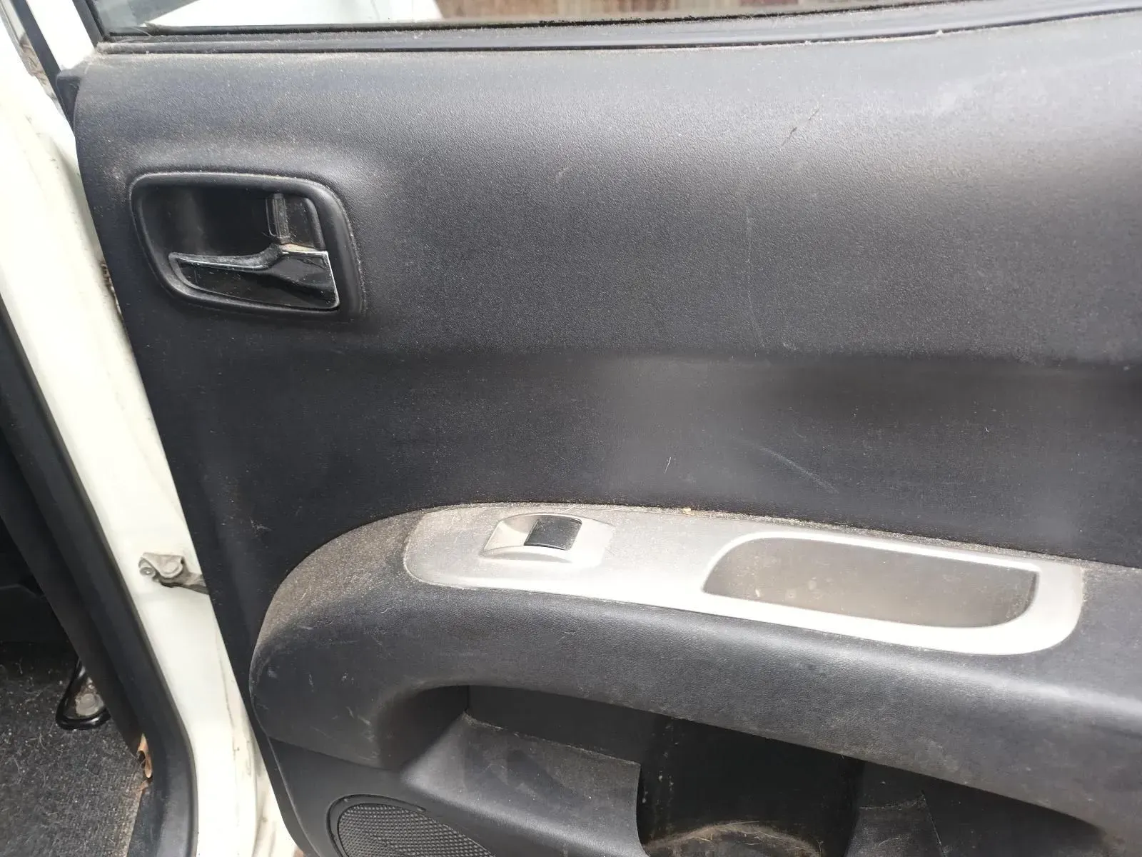 Dirty Black Car Door Panel With Silver Trim and Broken Handle — South West 4WD Wreckers In Brisbane, QLD