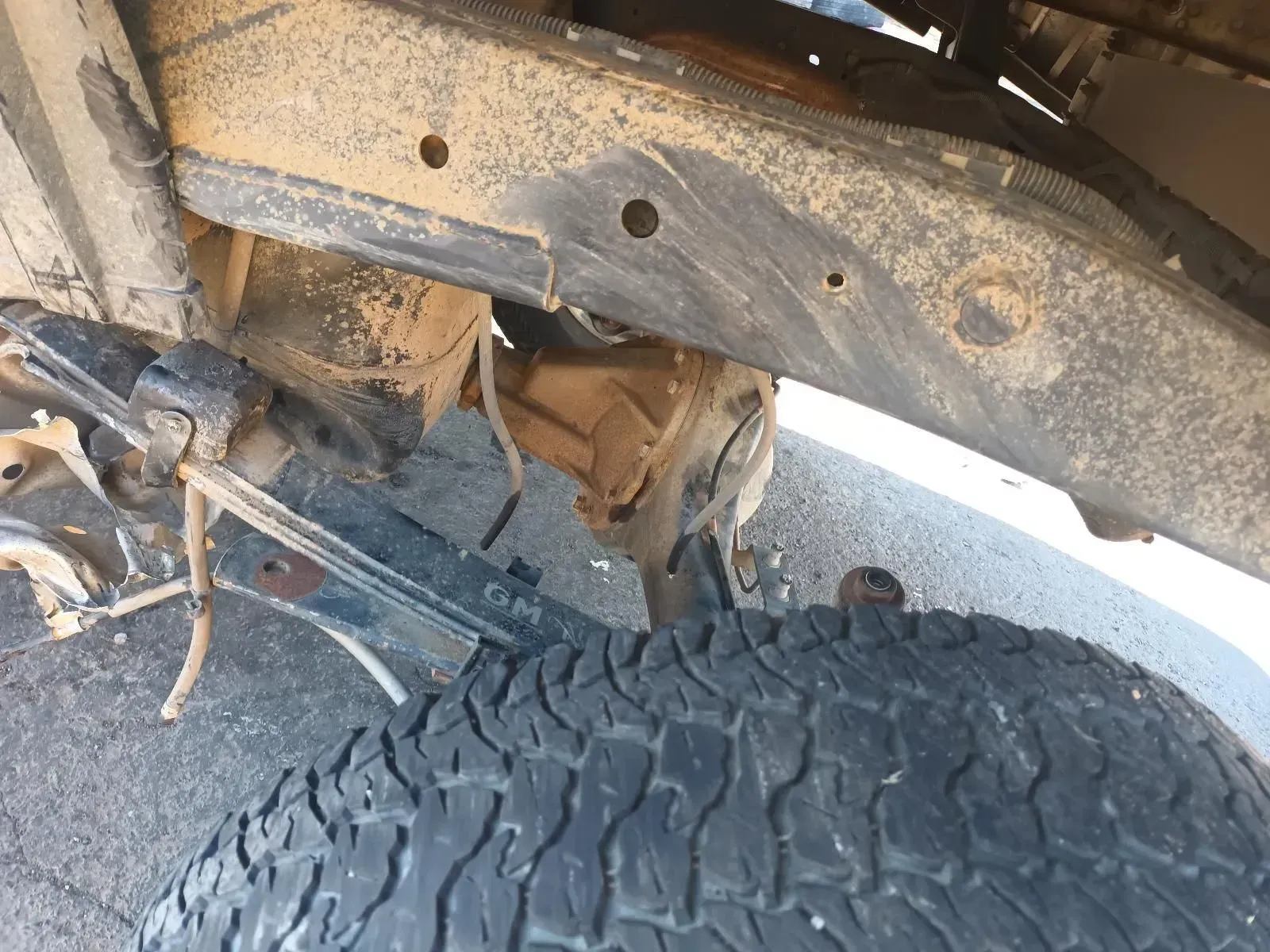 A Damaged Vehicle Frame With a Tyre Visible, Covered in Dirt and Rust — South West 4WD Wreckers In Brisbane, QLD
