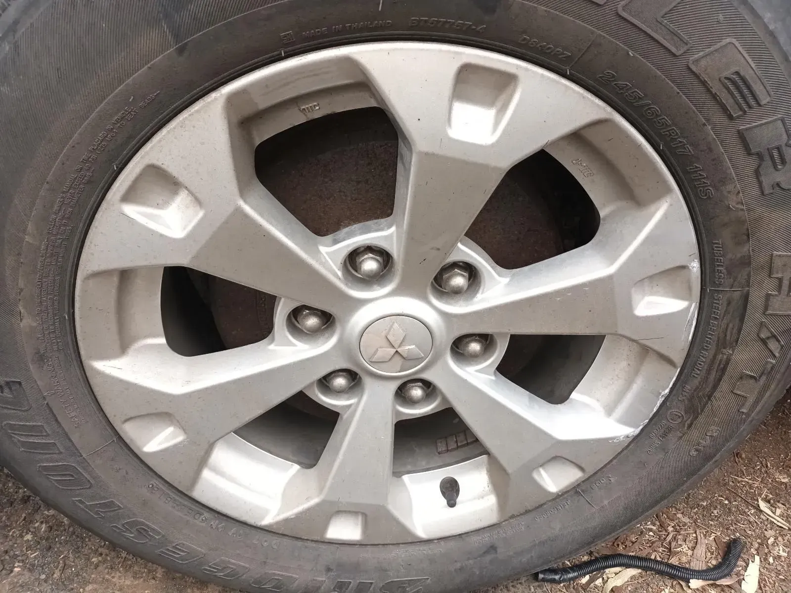 Silver Mitsubishi Car Wheel With a Black Tyre — South West 4WD Wreckers In Brisbane, QLD