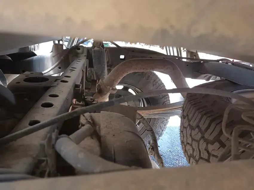 A Close Up of the Underside of a Truck With a Tire in the Foreground — South West 4WD Wreckers In Brisbane, QLD