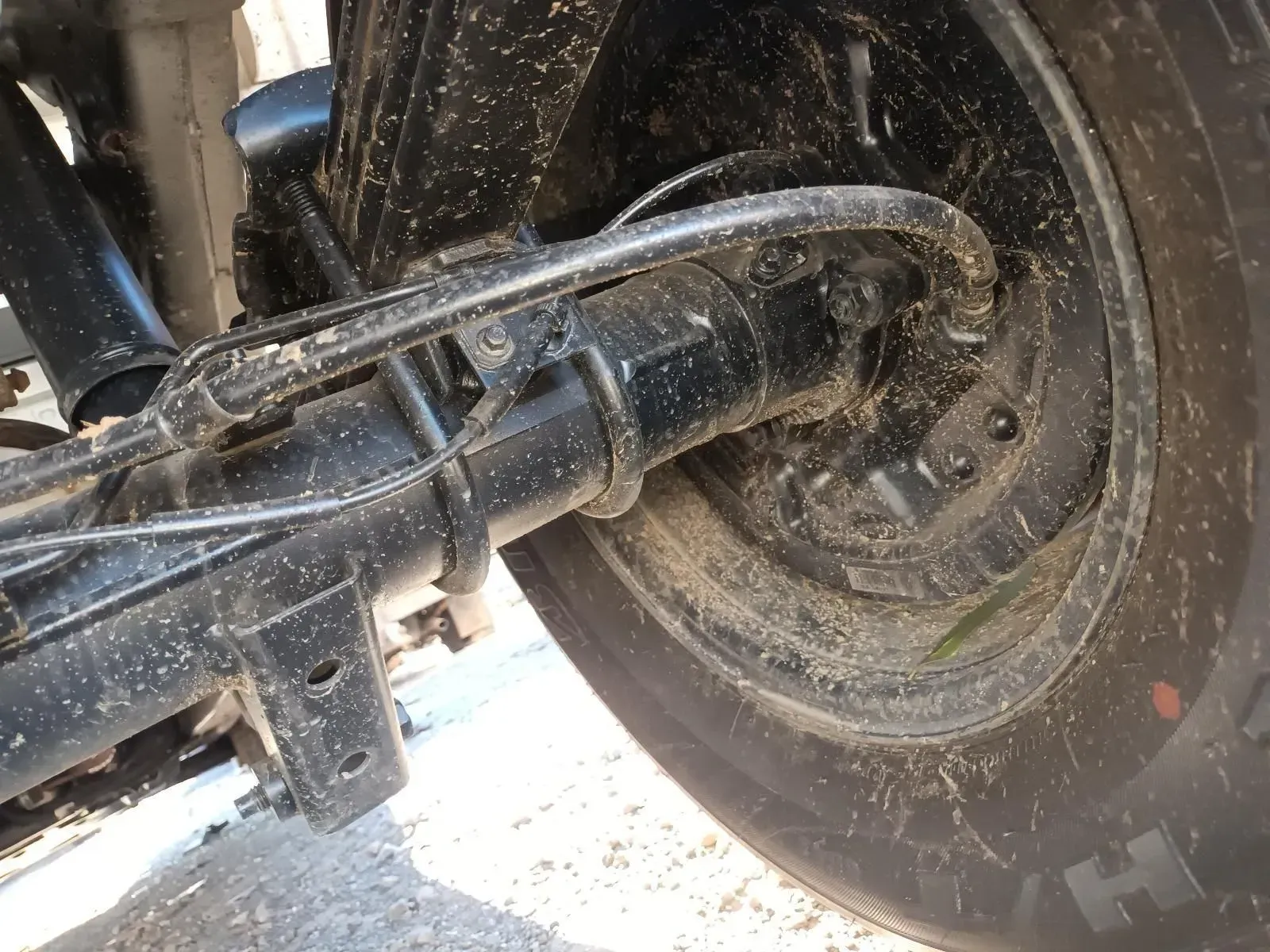 Black Truck Axle and Wheel, Covered in Dirt — South West 4WD Wreckers In Brisbane, QLD
