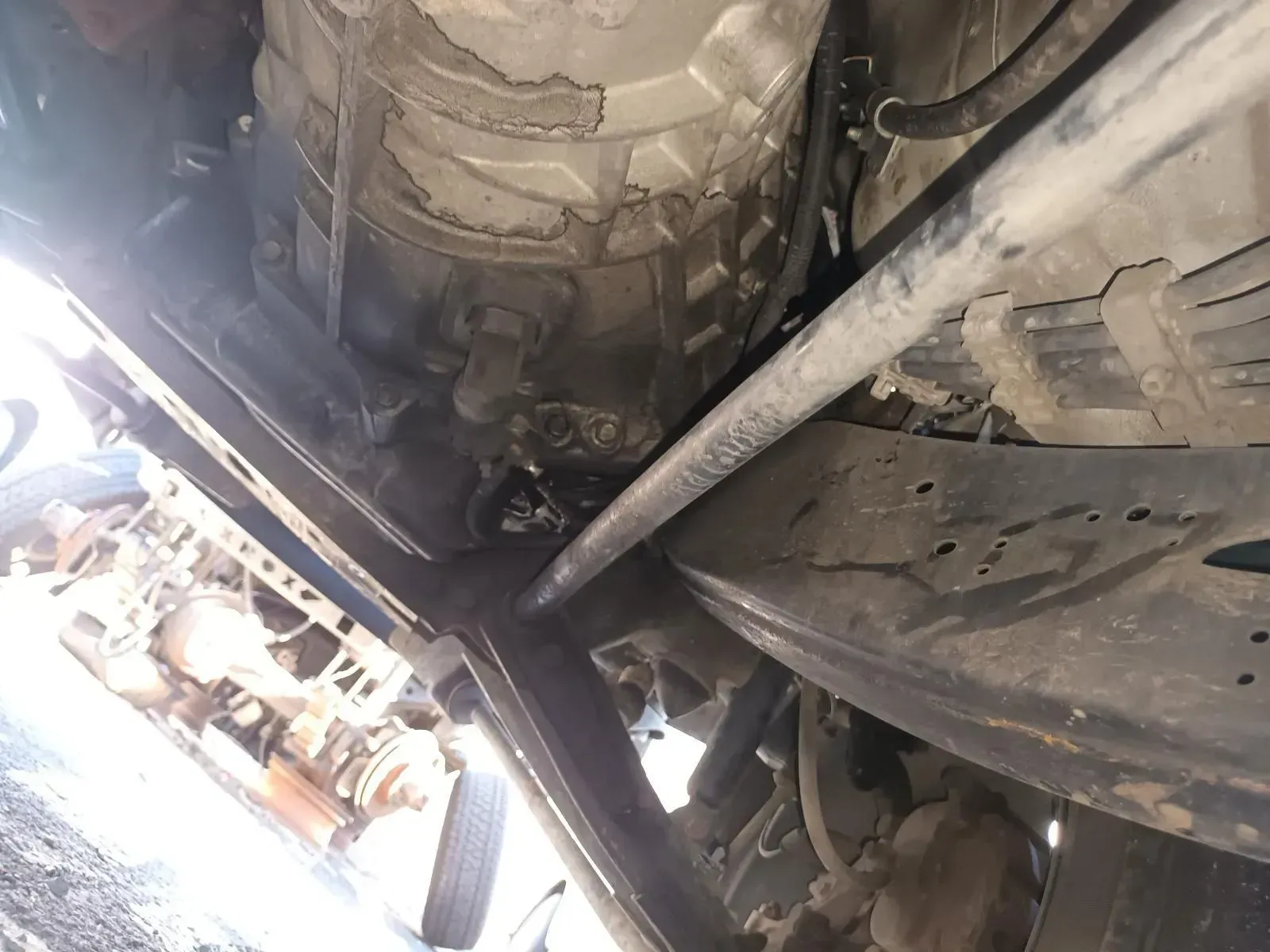 Undercarriage of a Vehicle With Visible Fluid Leaks and Various Metal Components — South West 4WD Wreckers In Brisbane, QLD