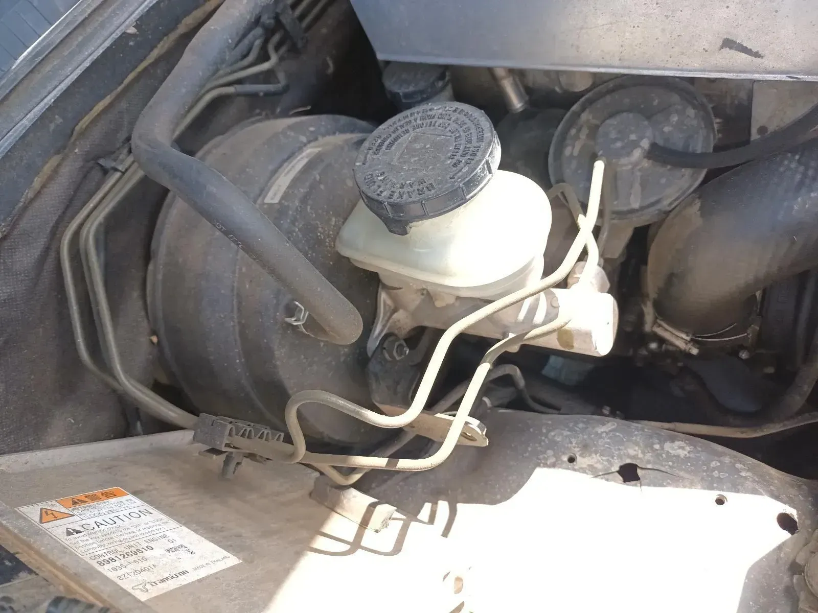Car Engine Bay With Brake Fluid Reservoir, Master Cylinder, and Tubing — South West 4WD Wreckers In Brisbane, QLD