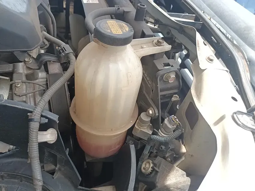 A Bottle of Coolant is Sitting Under the Hood of a Car — South West 4WD Wreckers In Brisbane, QLD