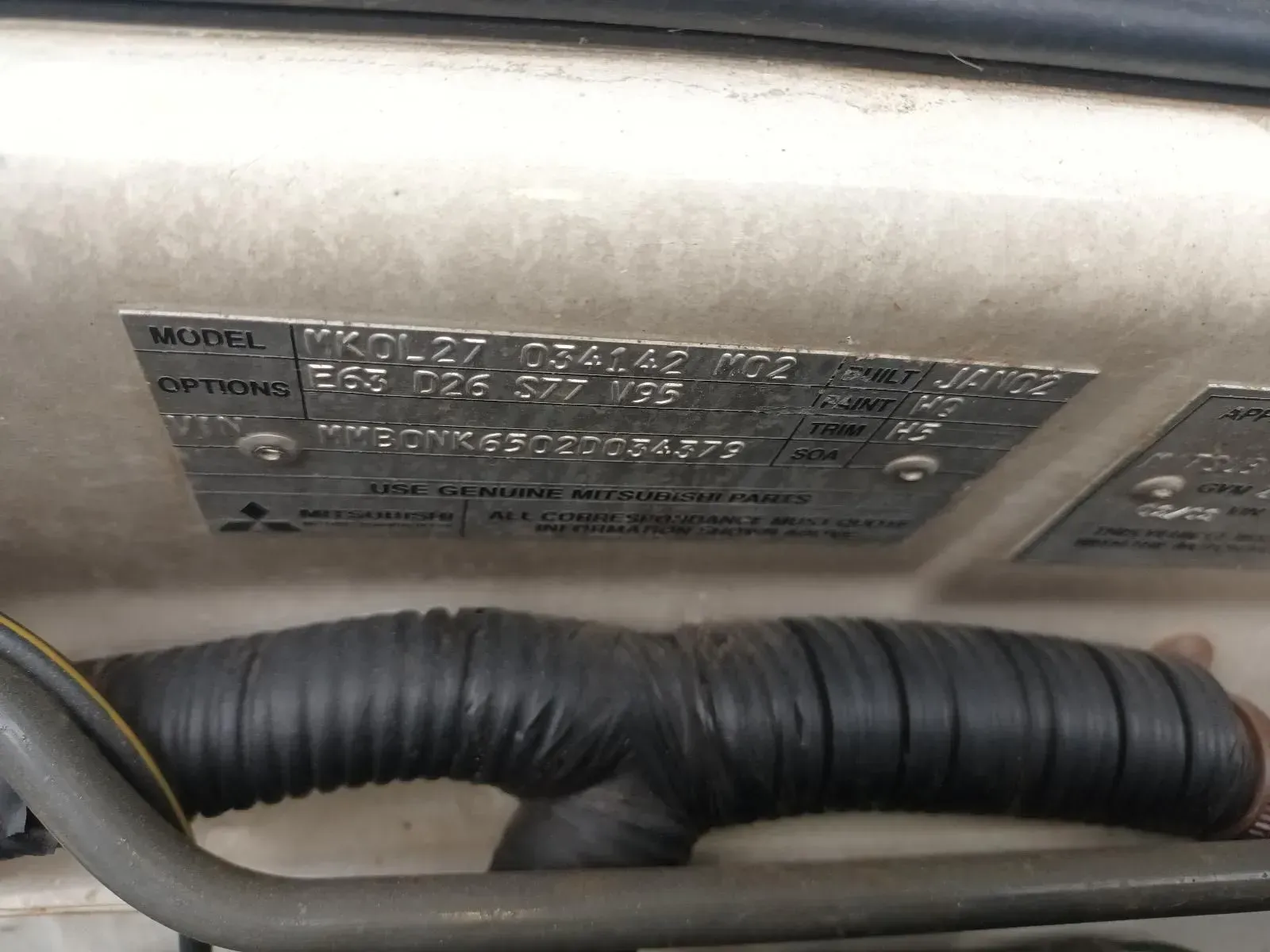 Metal Vehicle Identification Plate, With Black Text, Mounted on a White Surface — South West 4WD Wreckers In Brisbane, QLD