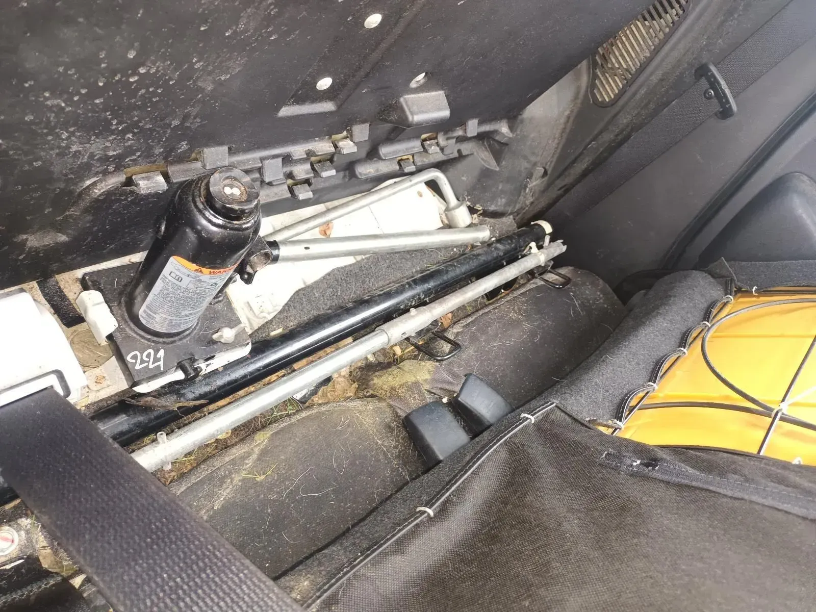 Black Car Jack and Wrench Tucked Inside the Vehicle's Dirty Trunk — South West 4WD Wreckers In Brisbane, QLD