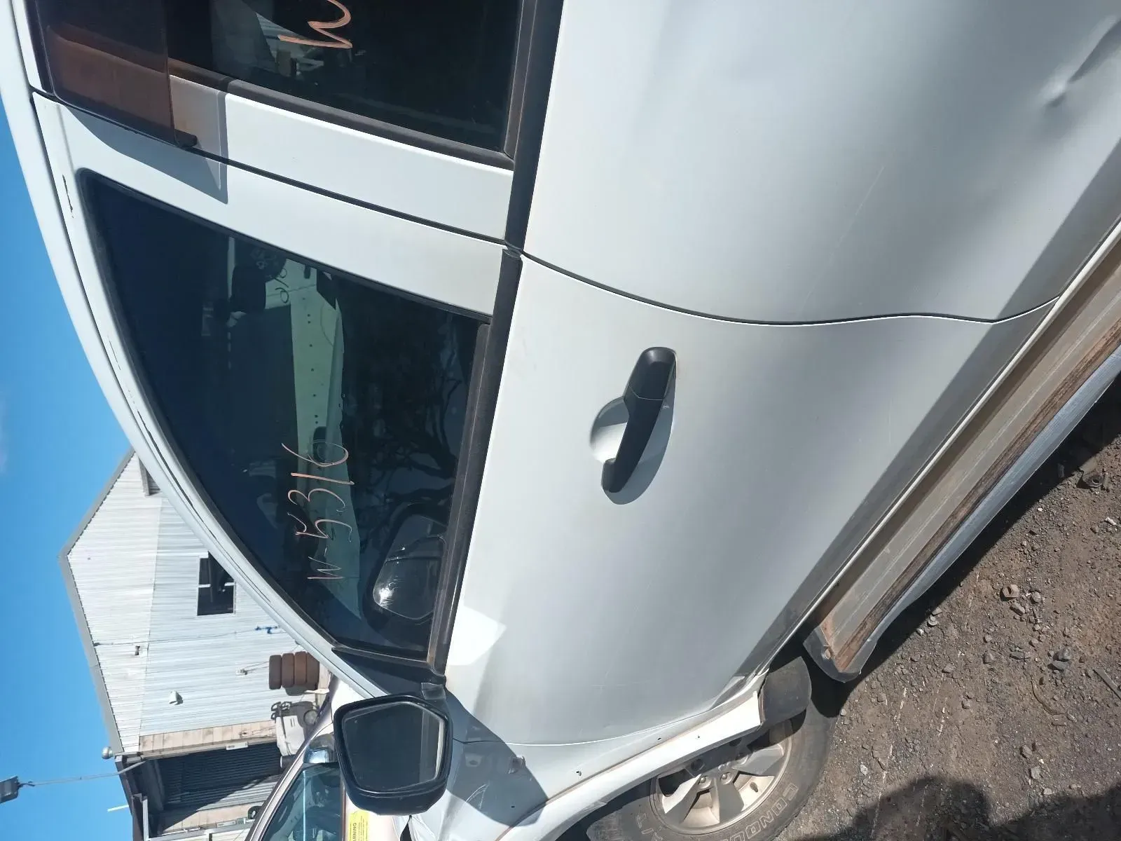 Side View of a Silver Car With Door Handle, in an Outdoor Junkyard Setting — South West 4WD Wreckers In Brisbane, QLD