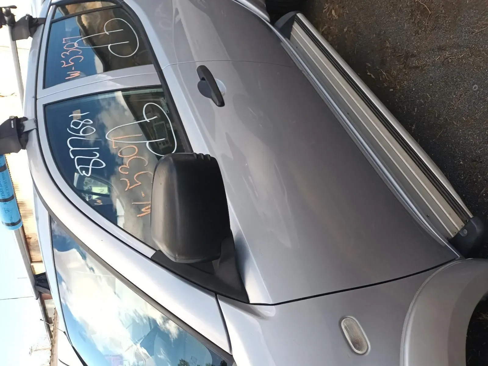Silver Car With Running Boards and a Black Side Mirror in a Junkyard — South West 4WD Wreckers In Brisbane, QLD