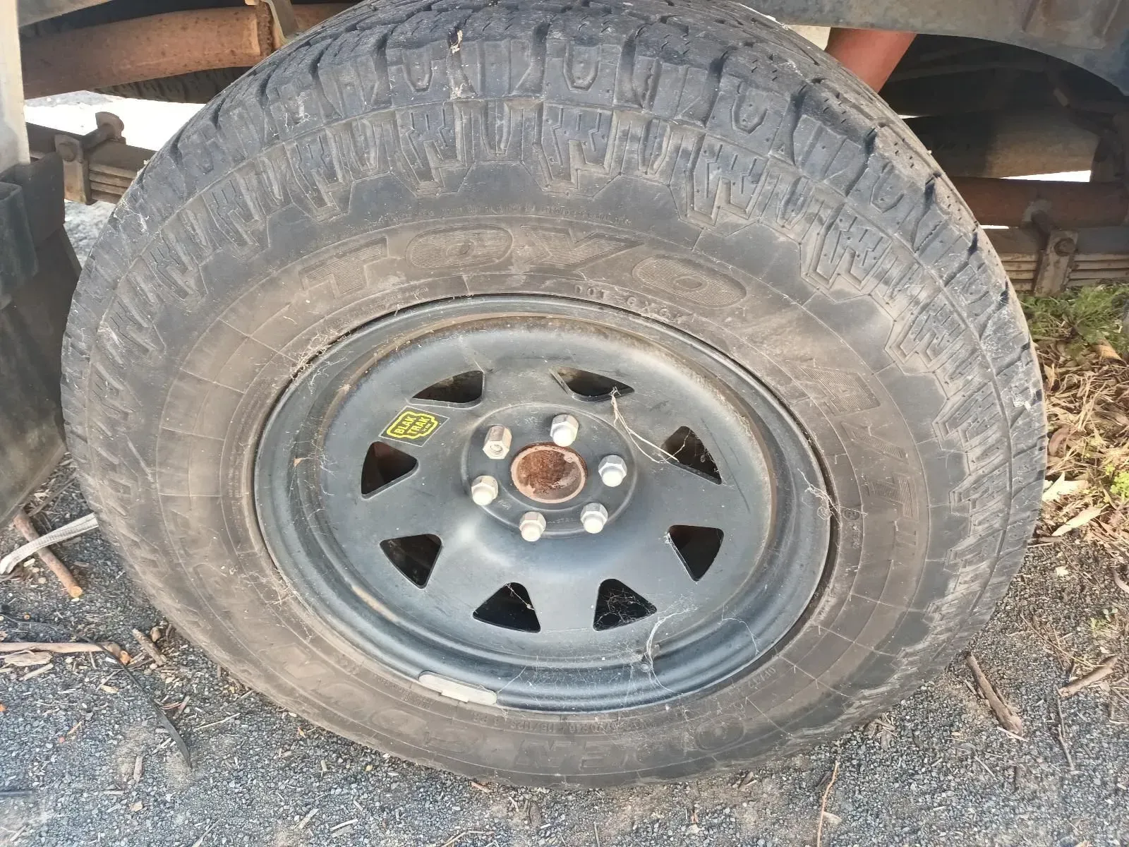 A Worn Black Tyre on a Gray Steel Rim — South West 4WD Wreckers In Brisbane, QLD