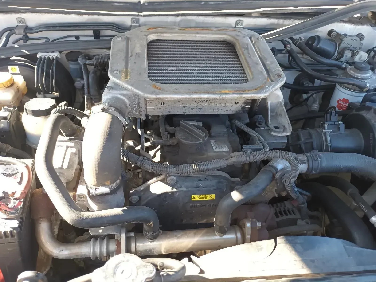 Engine Bay of a White Vehicle, Featuring a Dusty Air Filter Cover — South West 4WD Wreckers In Brisbane, QLD