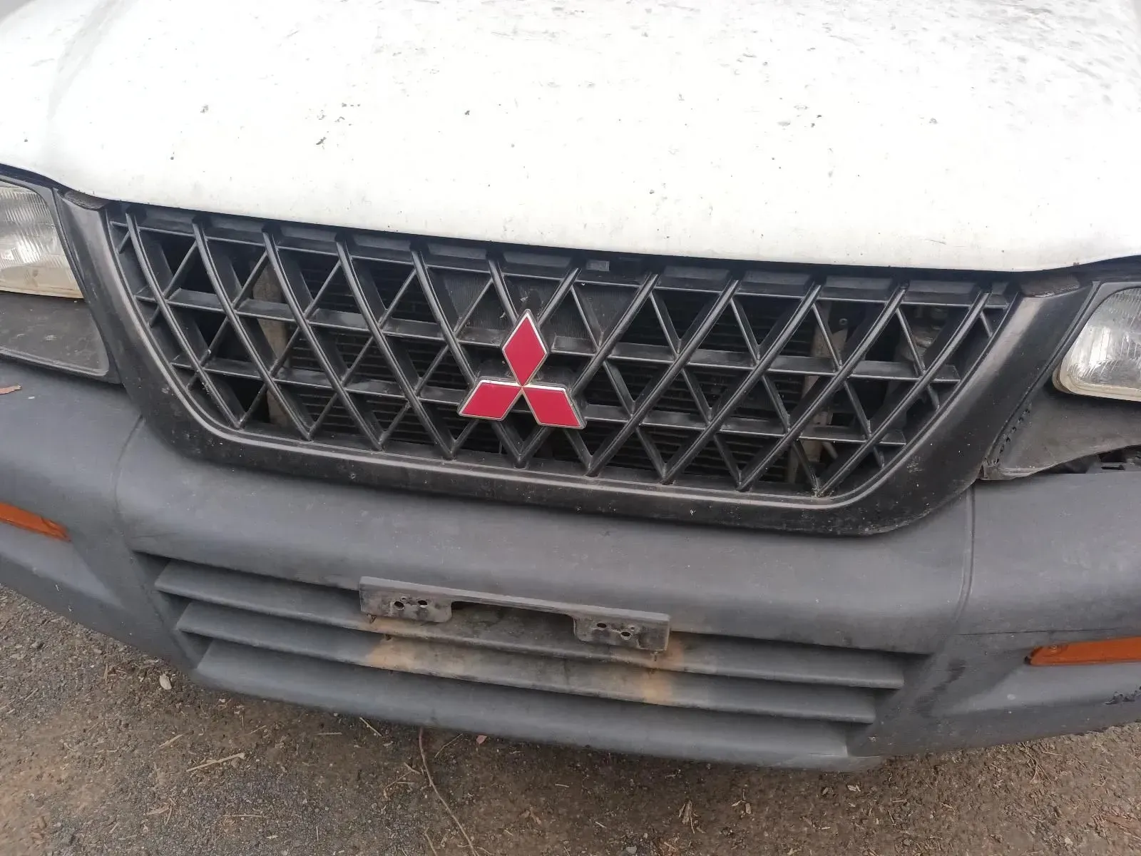 Mitsubishi Vehicle Front End With Black Grill and Red Logo — South West 4WD Wreckers In Brisbane, QLD