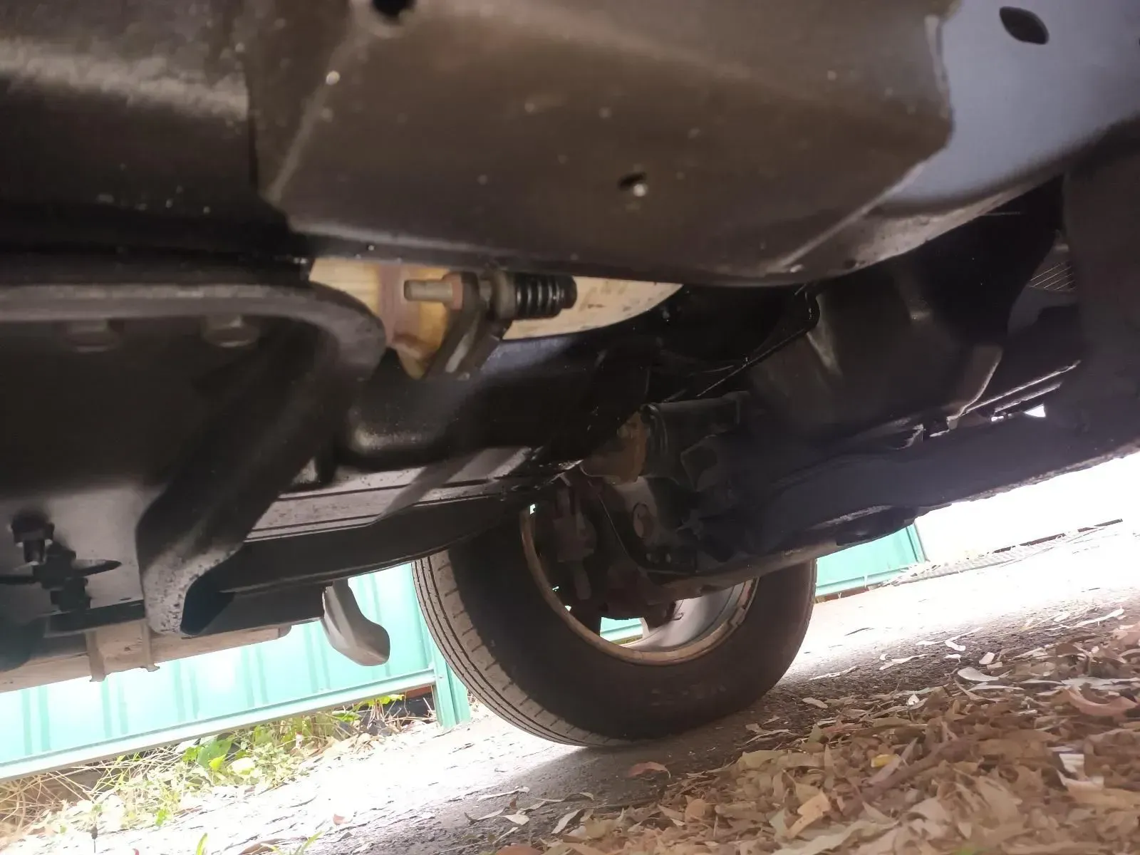 Underside of a Black Vehicle, Showing the Chassis, Suspension, and a Tyre — South West 4WD Wreckers In Brisbane, QLD