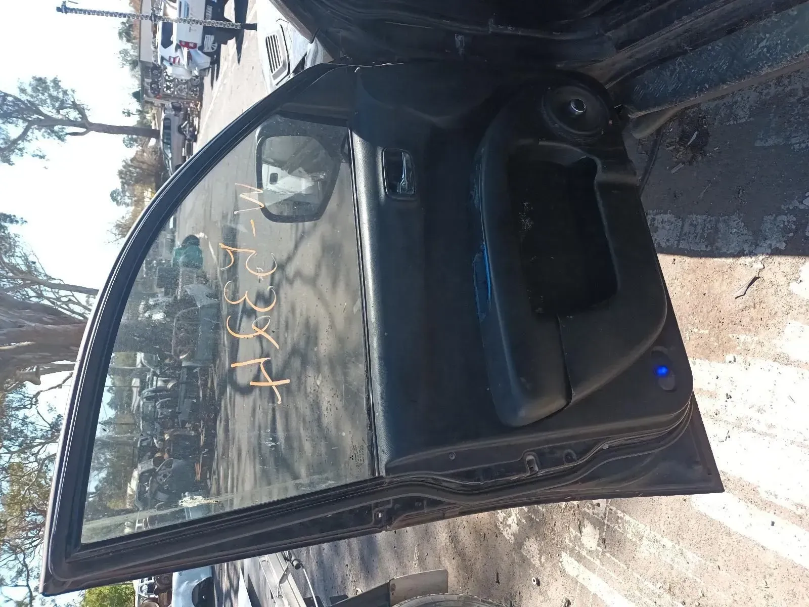 Black Car Door With Glass Window, Open in a Junkyard Setting — South West 4WD Wreckers In Brisbane, QLD