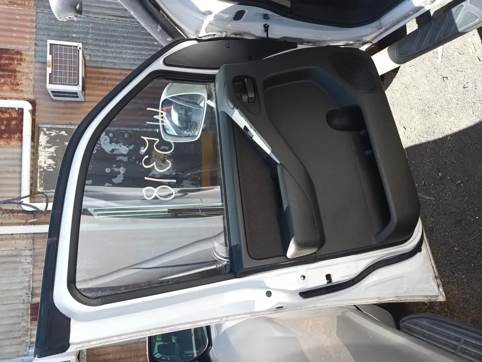 White Car Door With Mirror, Open, Leaning Against a Salvage Yard Backdrop — South West 4WD Wreckers In Brisbane, QLD