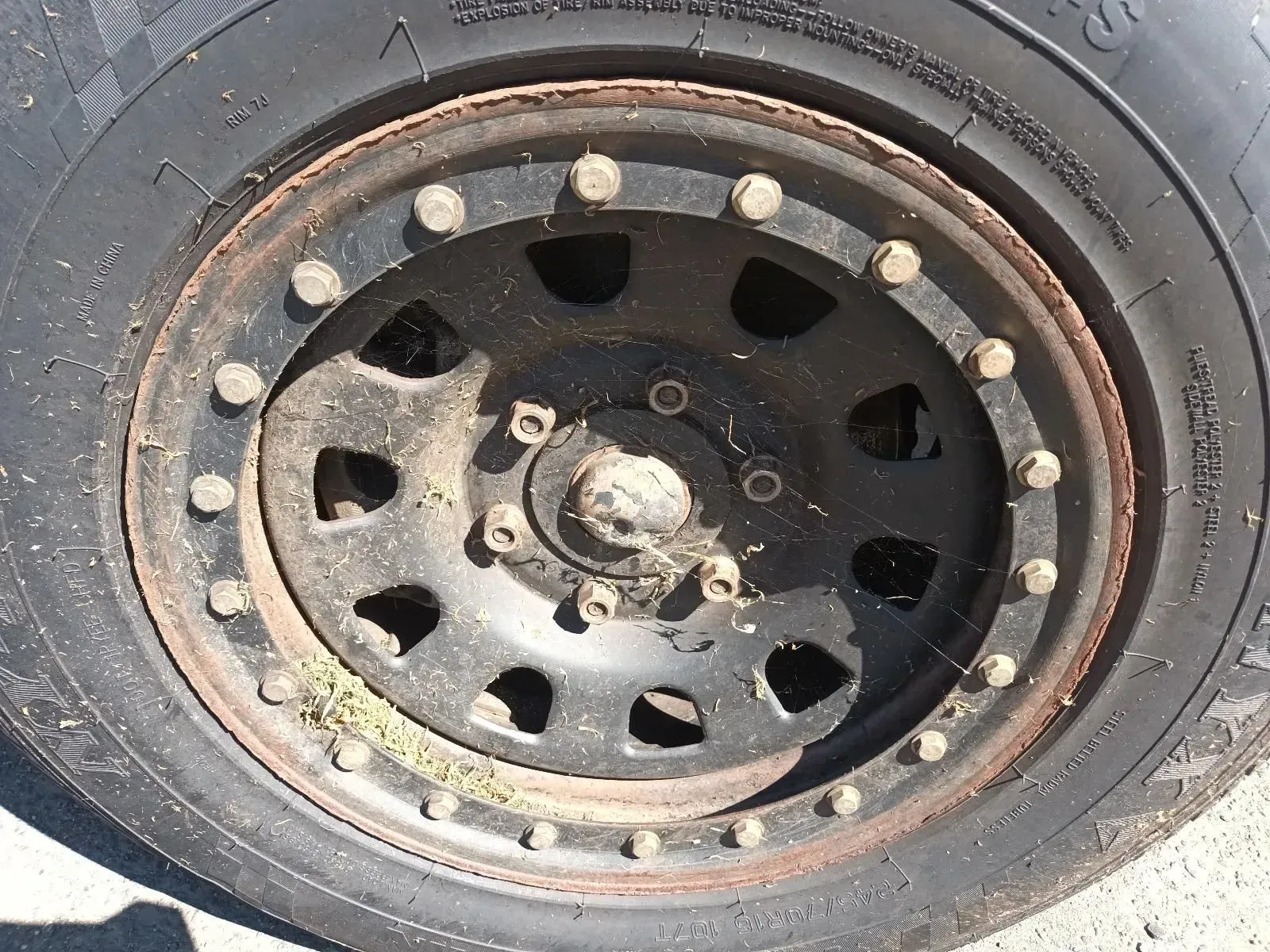 Black Off-road Wheel With Many Bolts, Rusted Rim, and Rubber Tyre — South West 4WD Wreckers In Brisbane, QLD