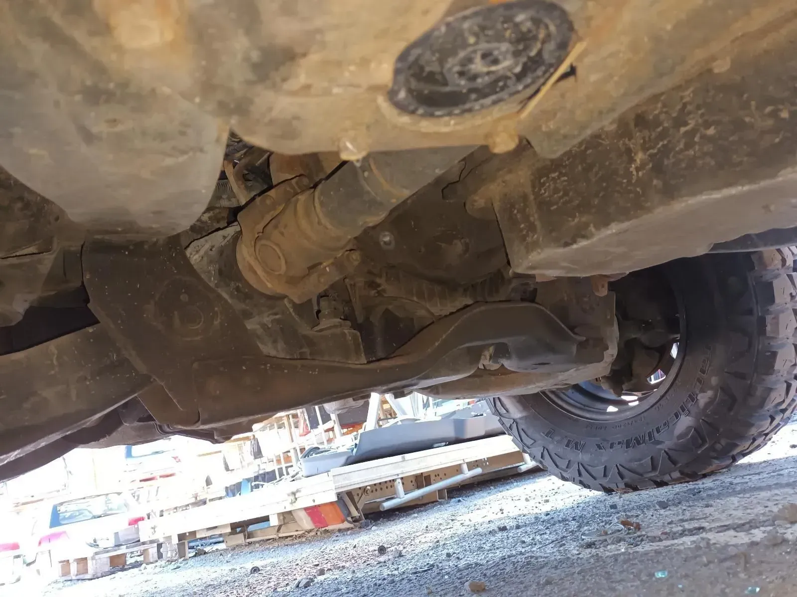 Undercarriage of a Vehicle, Showing Suspension Components, Driveshaft, and Tyre — South West 4WD Wreckers In Brisbane, QLD