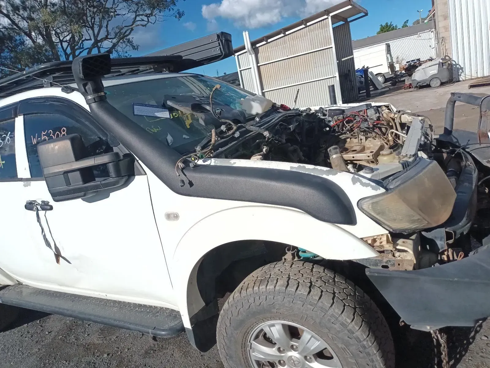White Truck With Snorkel, Missing Hood, and Engine Exposed, in a Salvage Yard — South West 4WD Wreckers In Brisbane, QLD