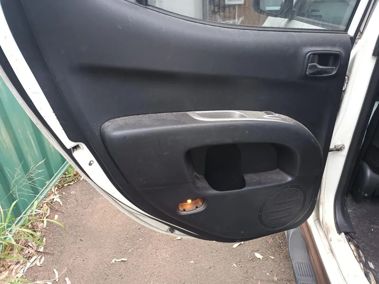 Open Car Door, Interior View, Showing Black Handle, Cup Holder, and Speaker — South West 4WD Wreckers In Brisbane, QLD