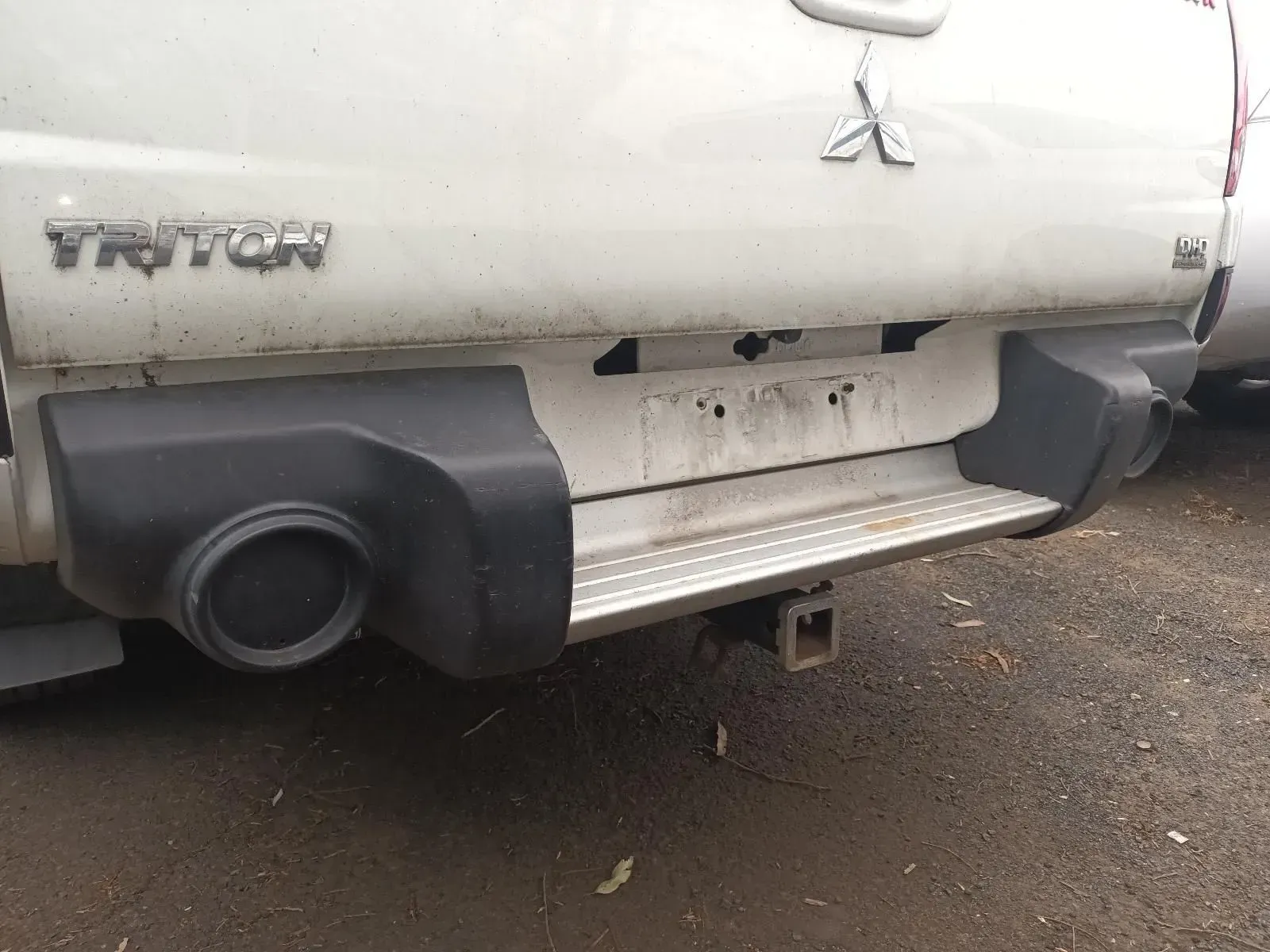 Rear View of a White Mitsubishi Triton Pickup Truck With a Black Bumper — South West 4WD Wreckers In Brisbane, QLD
