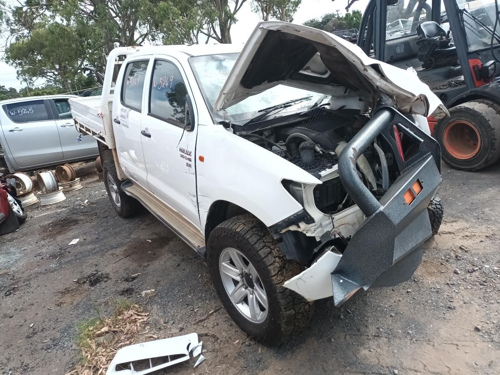 A White Truck with Its Hood Up is Sitting in a Lot — South West 4WD Wreckers in Harristown, QLD