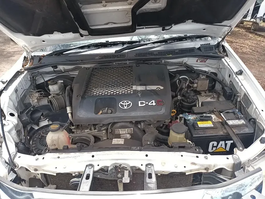 The Engine of a White Toyota Hilux is Shown with the Hood Up — South West 4WD Wreckers In Brisbane, QLD