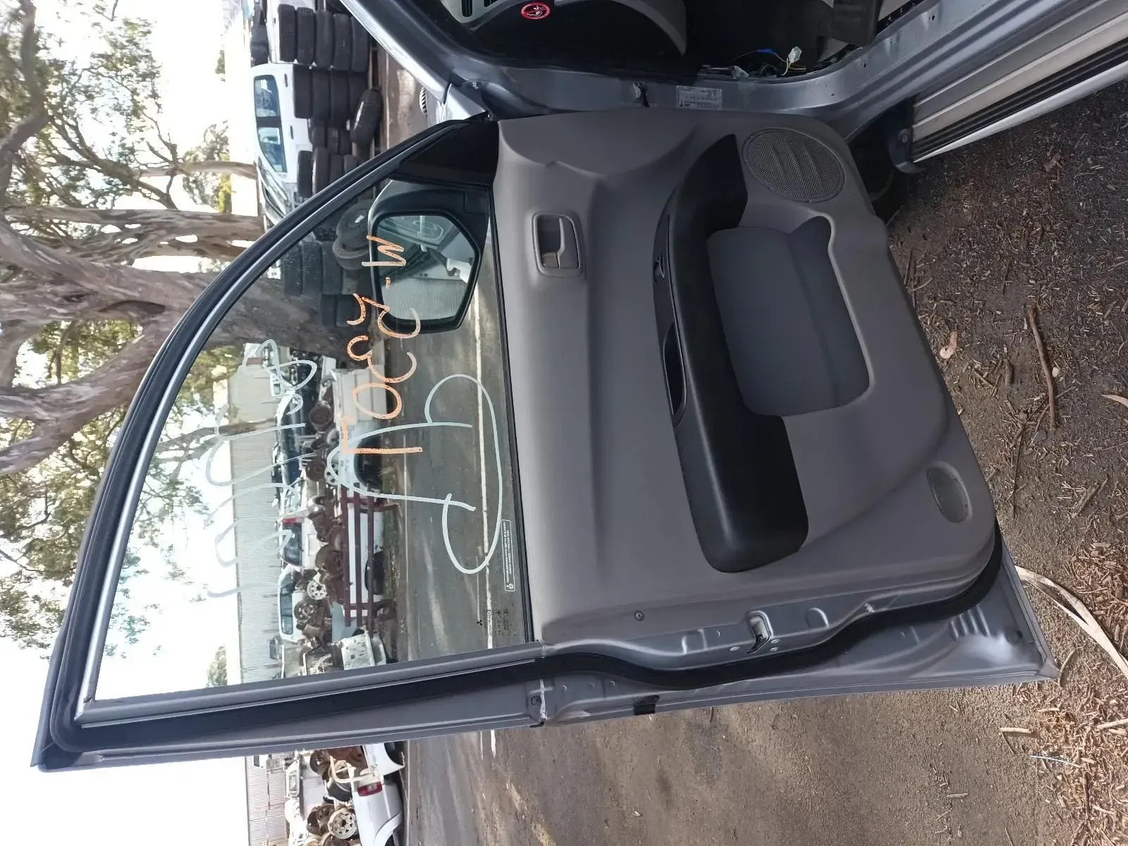 Gray Car Door Open, Revealing Window, Interior Panel, and Side Mirror — South West 4WD Wreckers In Brisbane, QLD