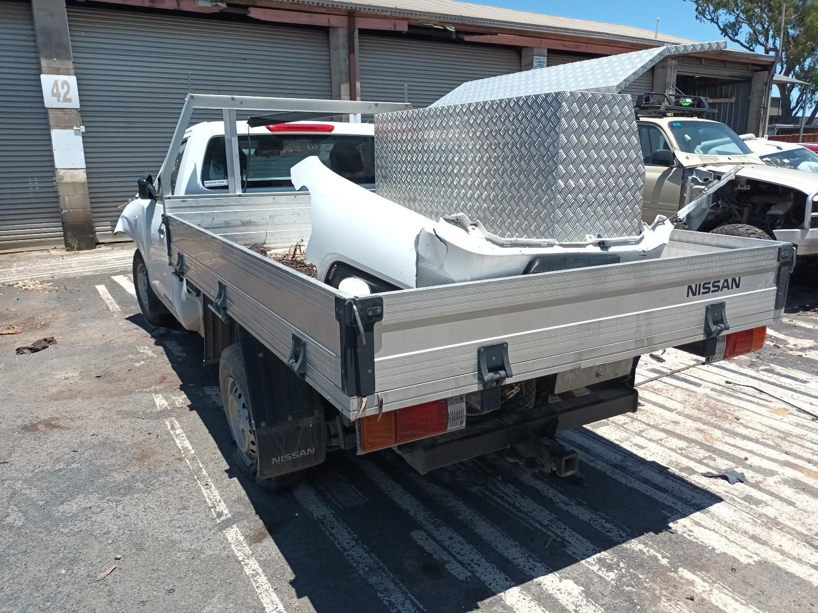 A White Truck with a Tray on the Back is Parked in a Parking Lot — South West 4WD Wreckers in Harristown, QLD