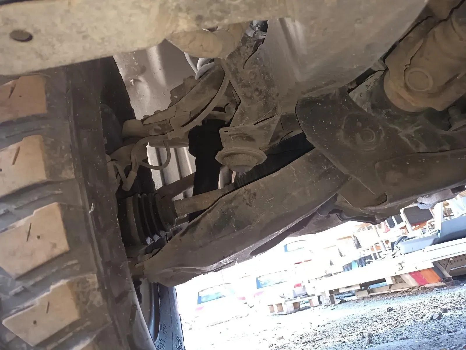 Undercarriage of a Vehicle, Showing Suspension Components, Axle, and Tyre — South West 4WD Wreckers In Brisbane, QLD