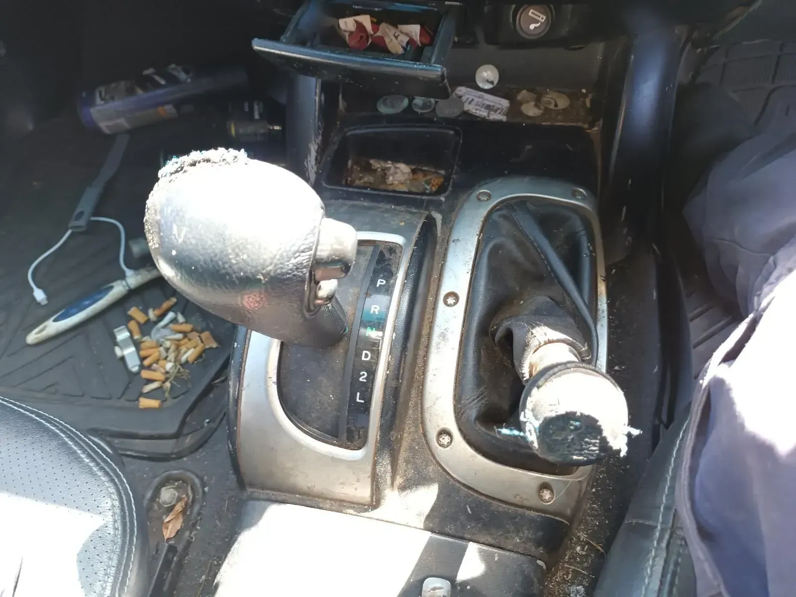 Dirty Car Interior With Gear Shifts, Cigarette Butts, and Debris — South West 4WD Wreckers In Brisbane, QLD