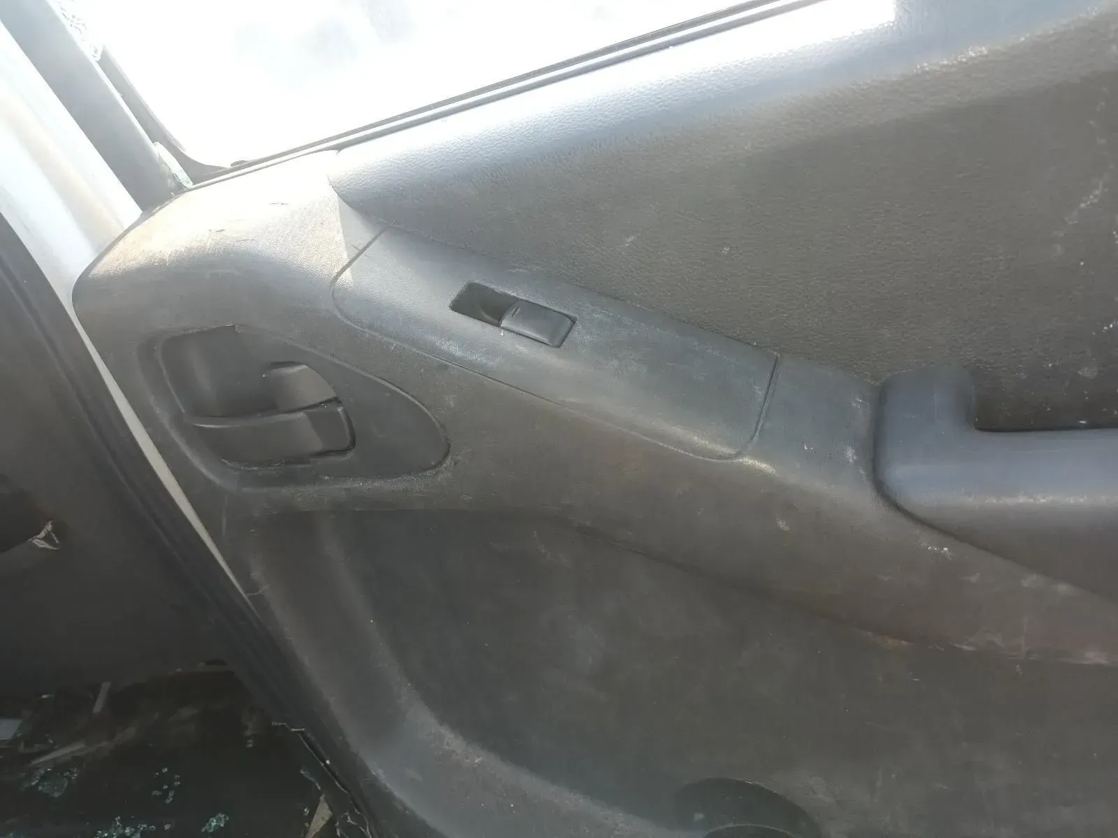 Black Car Door Panel With a Door Handle, Window Switch, and Armrest — South West 4WD Wreckers In Brisbane, QLD