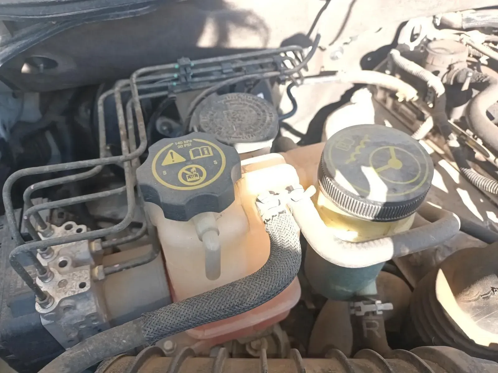 Car Engine With Various Fluid Reservoirs and Tubes, Likely a Brake System — South West 4WD Wreckers In Brisbane, QLD