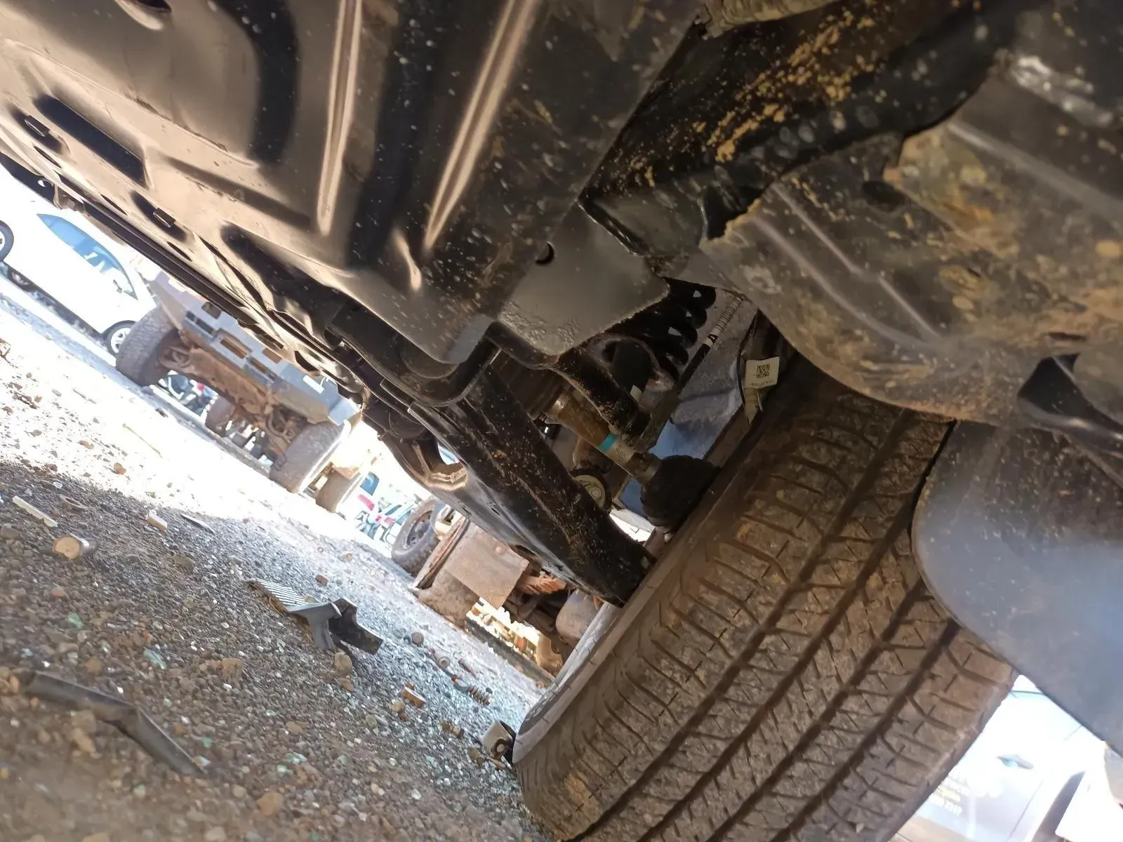 Undercarriage of a Vehicle, Showing Tyre, Suspension, and Rust-covered Metal — South West 4WD Wreckers In Brisbane, QLD