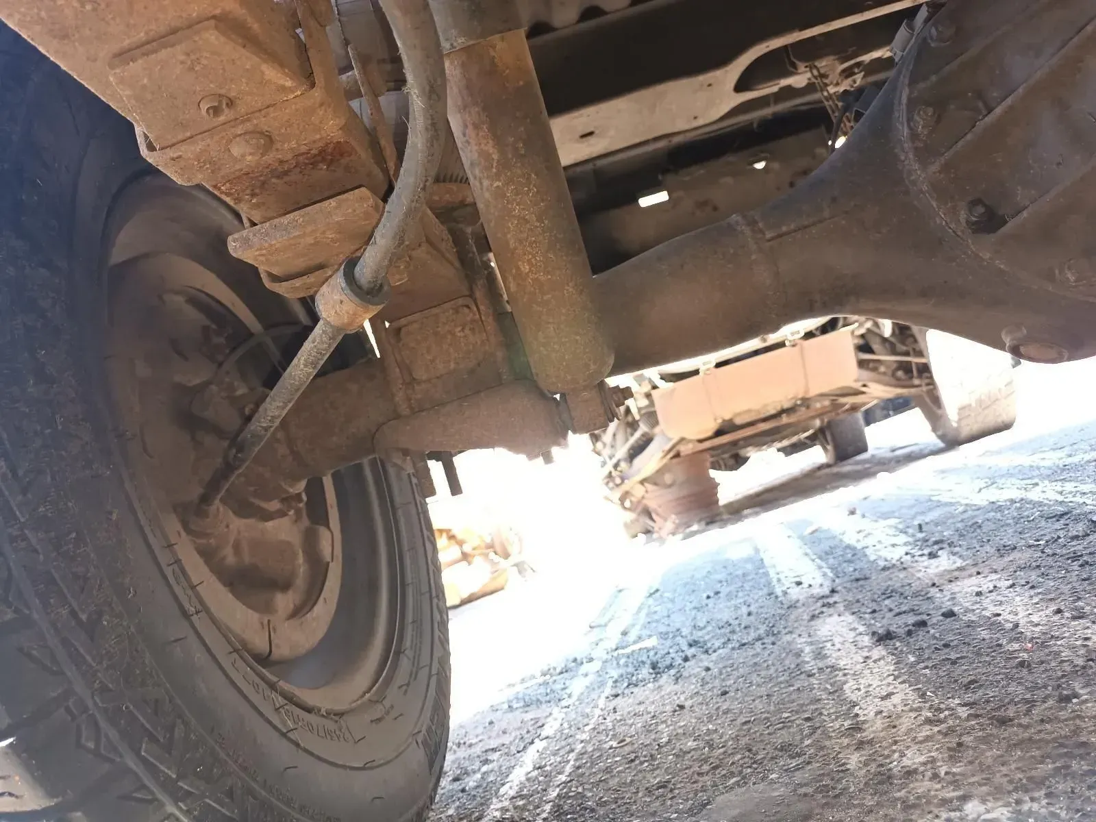 Rusty Truck Undercarriage, Showing Axle, Shock Absorber, and Wheel — South West 4WD Wreckers In Brisbane, QLD