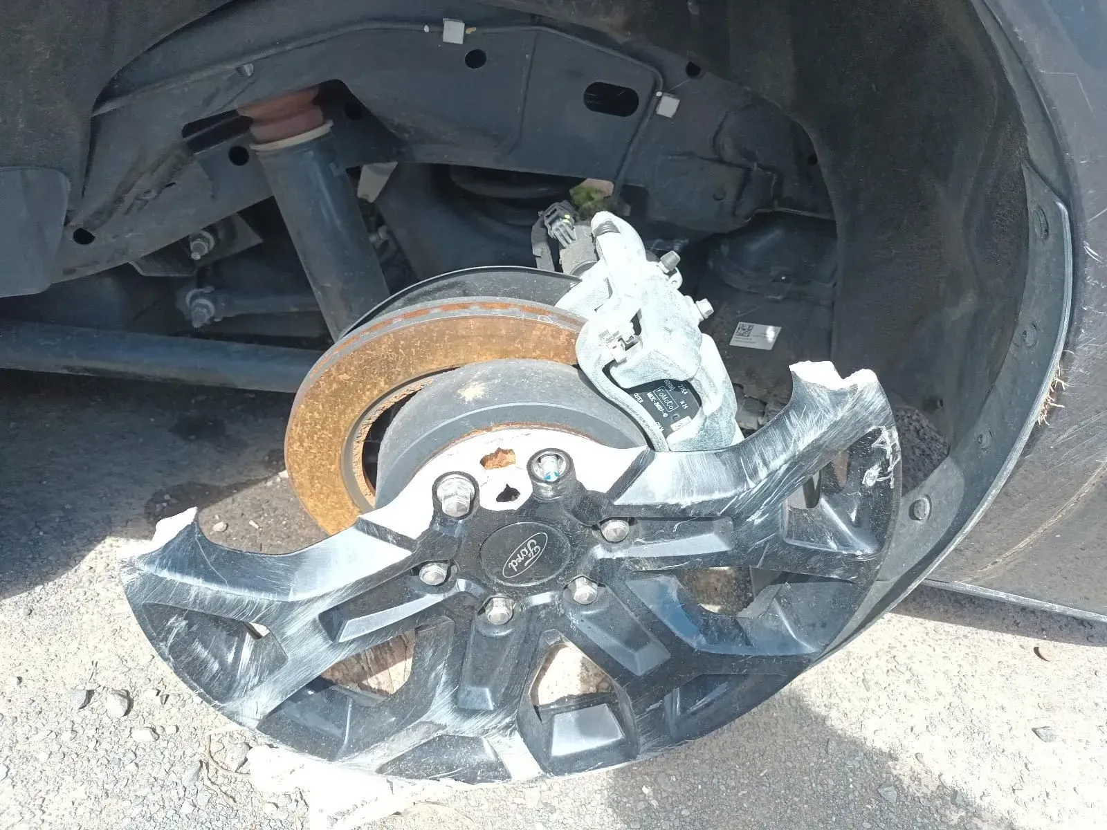 Damaged Car Wheel With Exposed Brake Rotor and Torn Cover — South West 4WD Wreckers In Brisbane, QLD