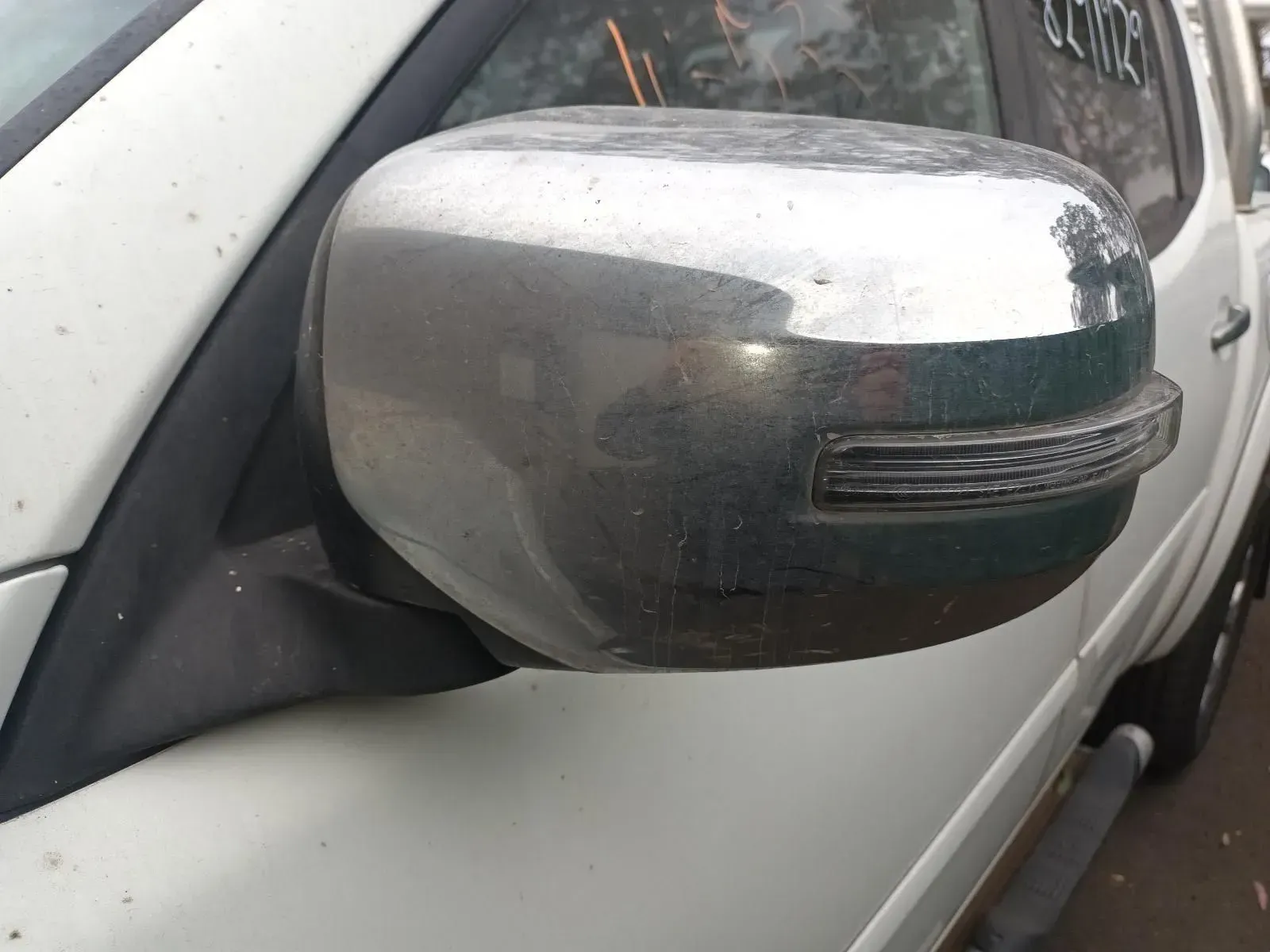 Side Mirror of a White Truck, Dusty Chrome Finish, With an Integrated Turn Signal — South West 4WD Wreckers In Brisbane, QLD