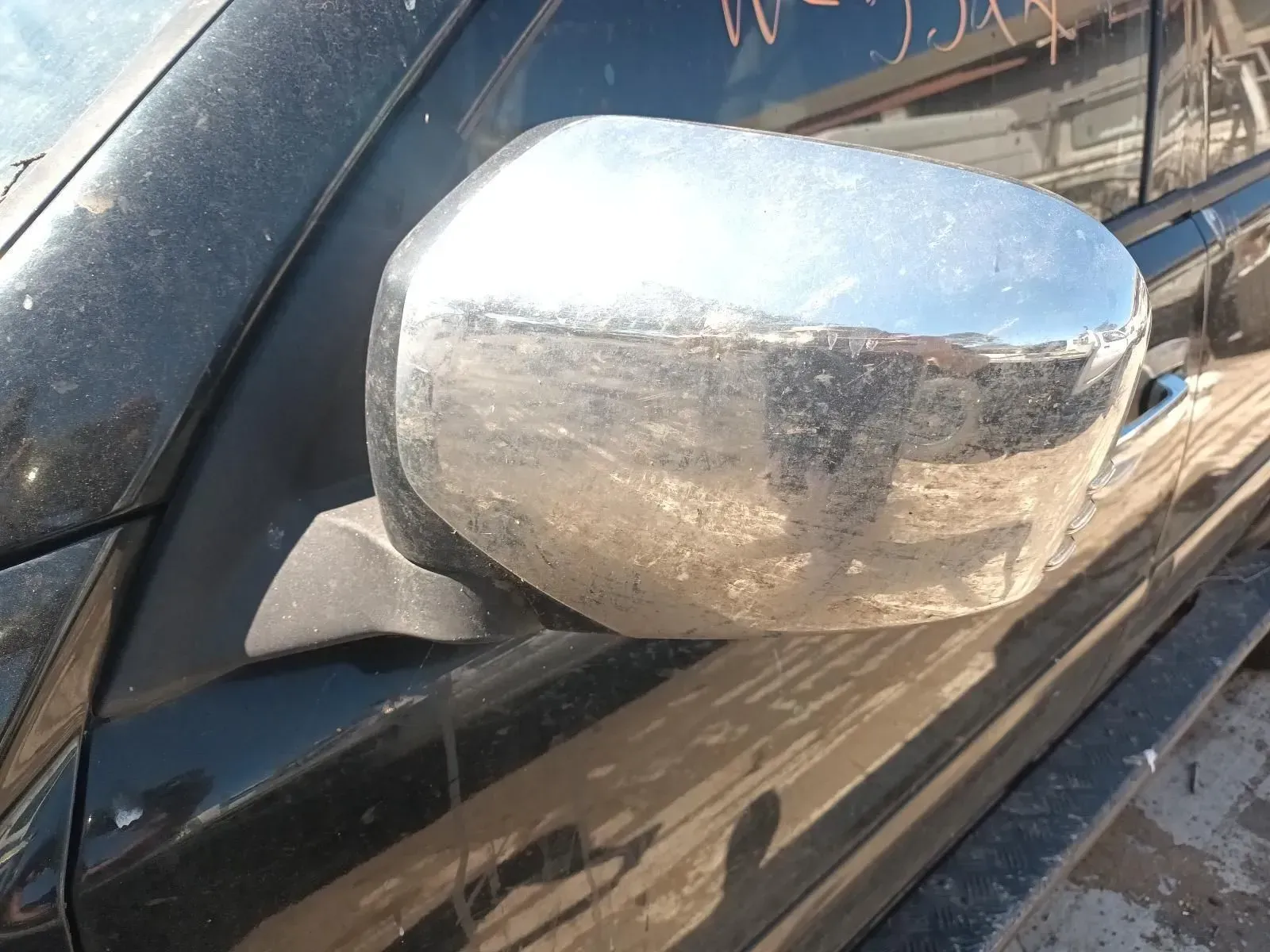 Chrome Side Mirror on a Black Vehicle, Dusty, in an Outdoor Setting — South West 4WD Wreckers In Brisbane, QLD