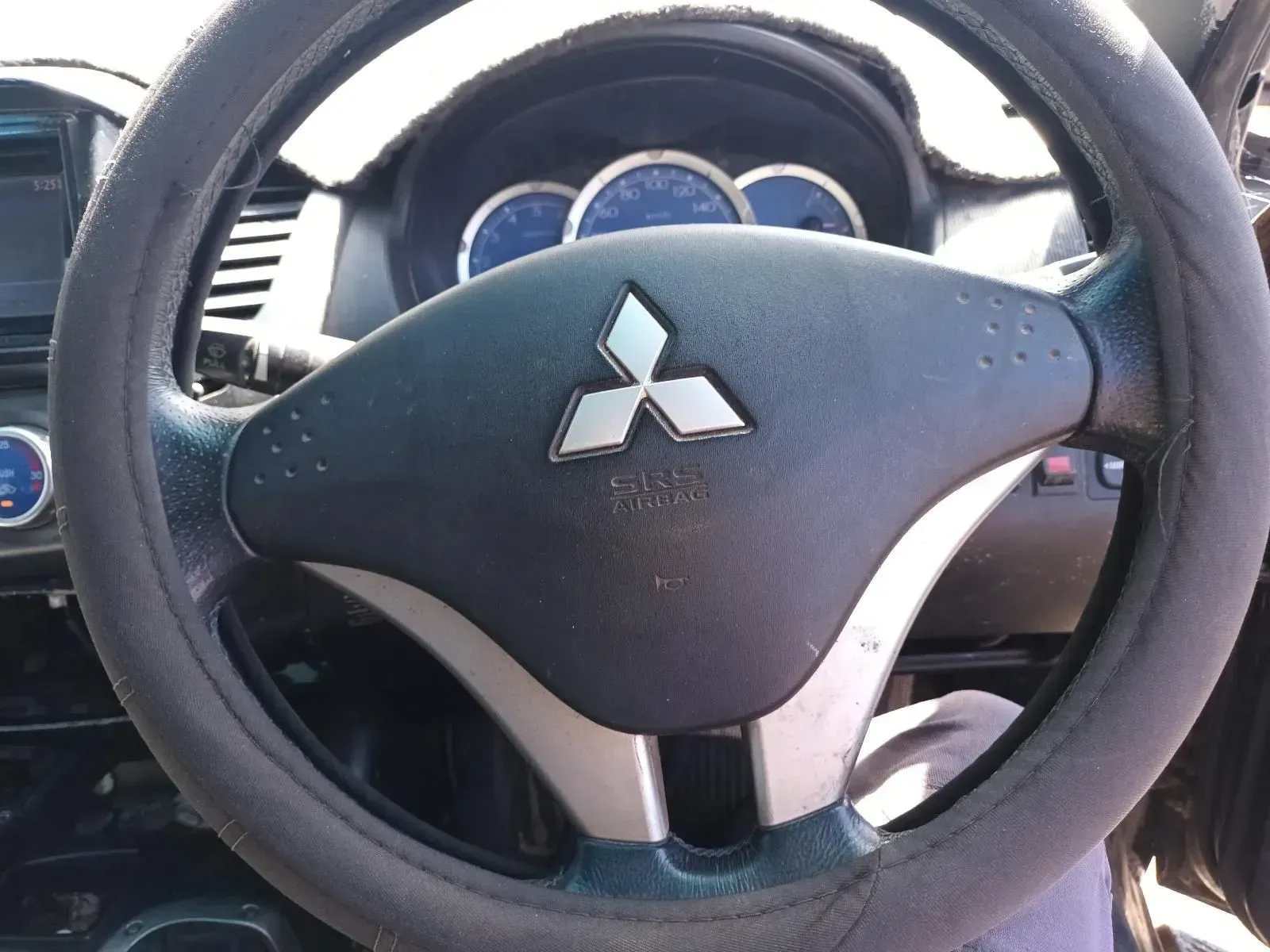 Mitsubishi Car Steering Wheel With Logo and Blue Dashboard Gauges — South West 4WD Wreckers In Brisbane, QLD