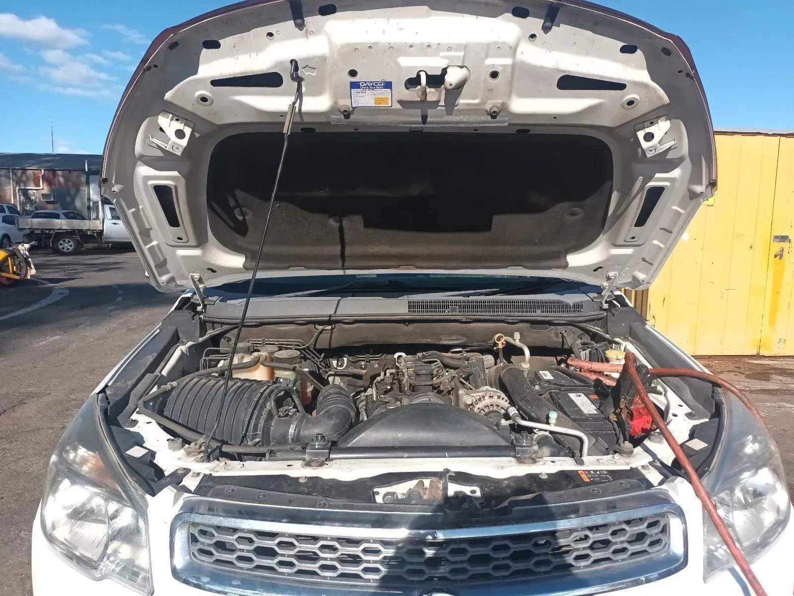 White Car With Hood Open Being Jump-started — South West 4WD Wreckers In Brisbane, QLD