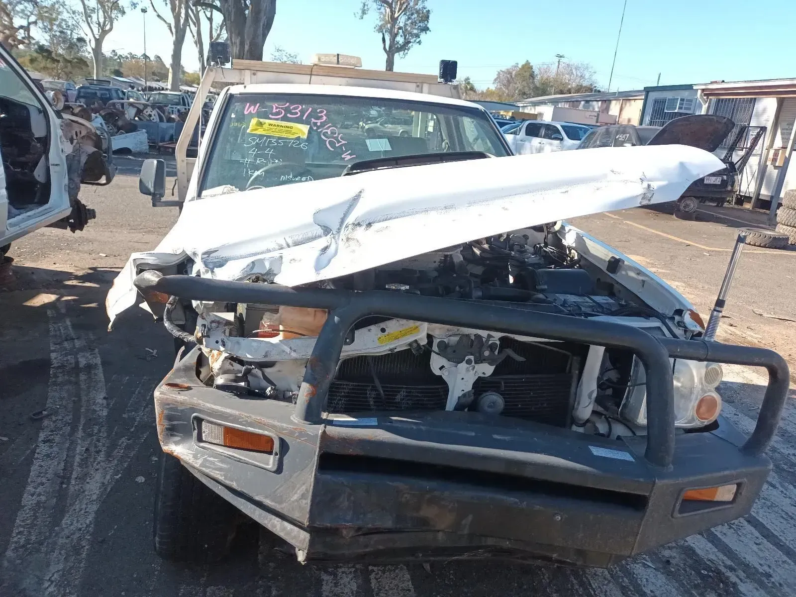 White Suv With Severe Front-end Damage in a Junkyard — South West 4WD Wreckers In Brisbane, QLD