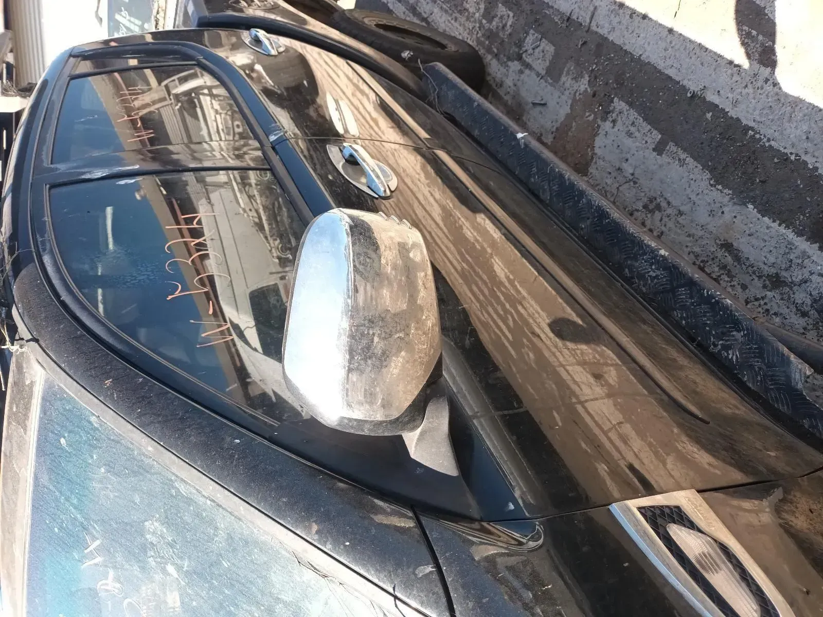 Black Car's Side Mirror, Window, and Roof in a Junkyard. Dirty and Damaged — South West 4WD Wreckers In Brisbane, QLD