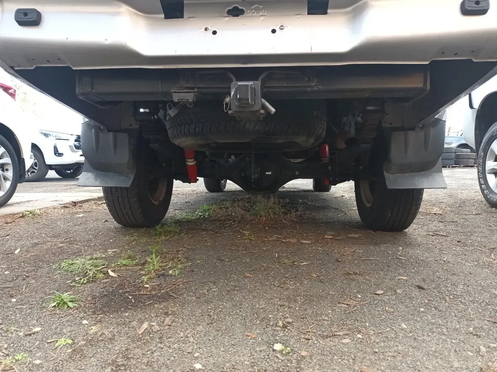 Underside of a Silver Truck, Hitch Visible, Parked on Gravel — South West 4WD Wreckers In Brisbane, QLD