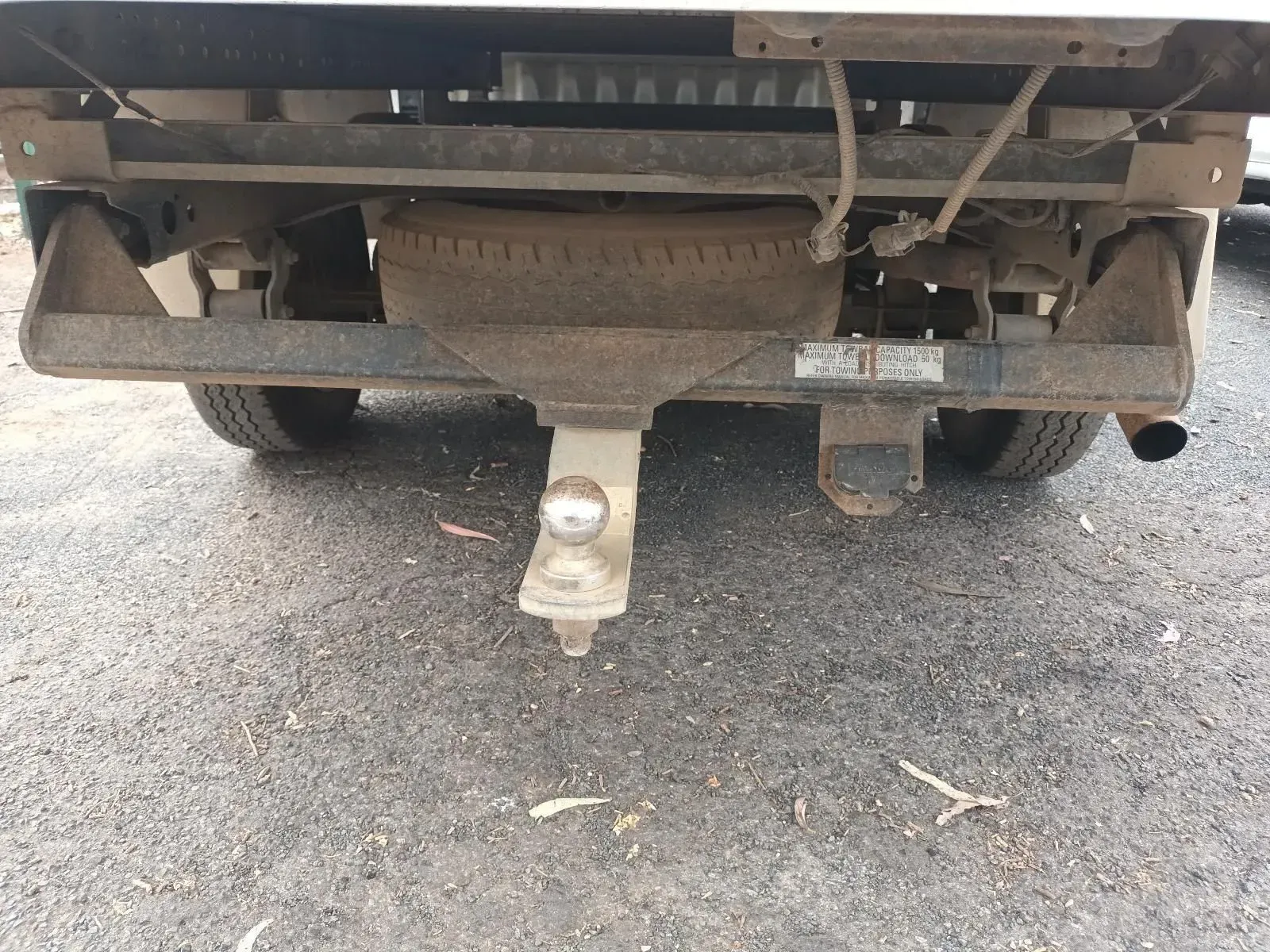 Rear View of a Work Truck With a Trailer Hitch, Spare Tyre, and Exhaust Pipe — South West 4WD Wreckers In Brisbane, QLD